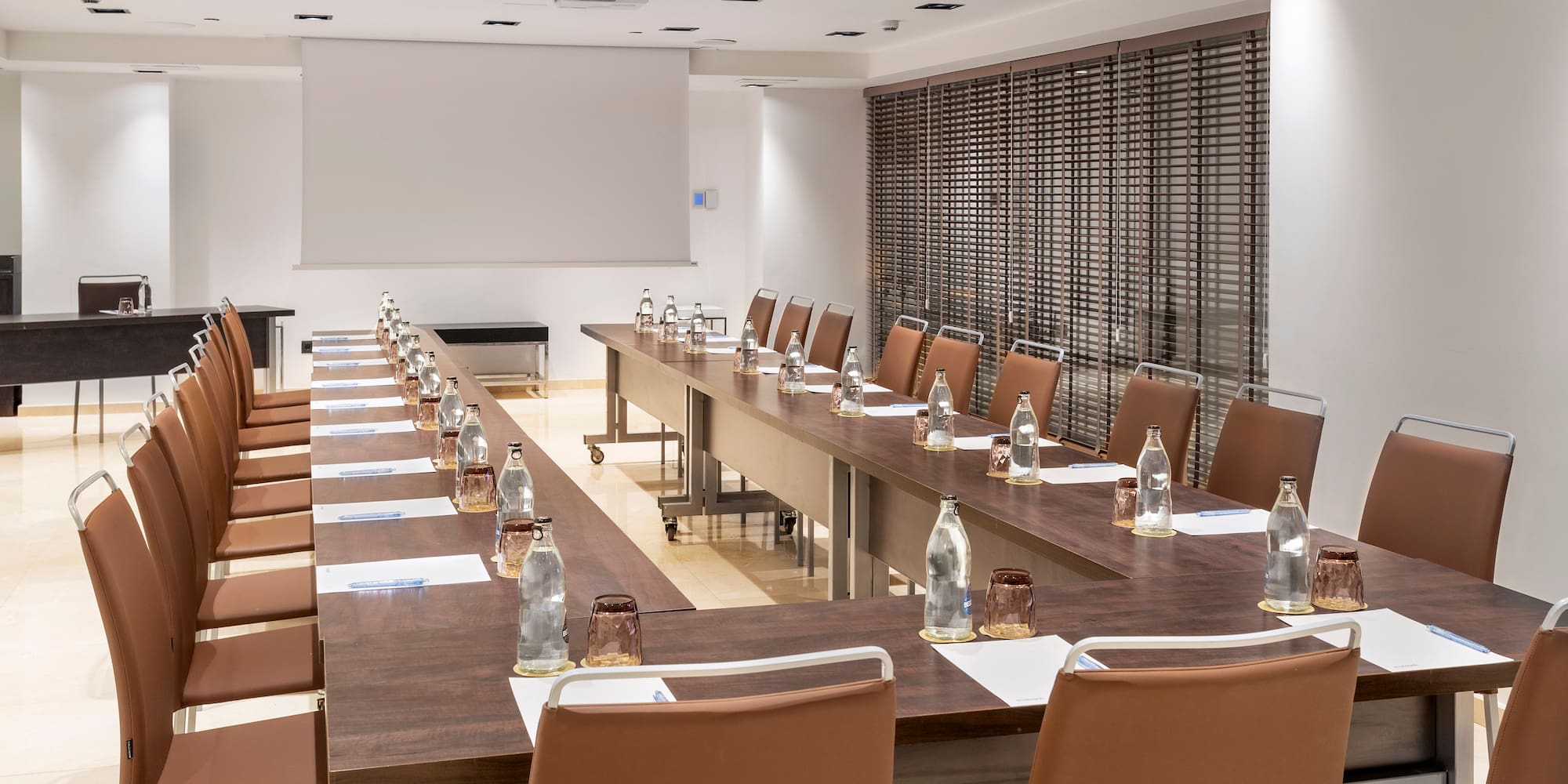 a room with long tables and chairs