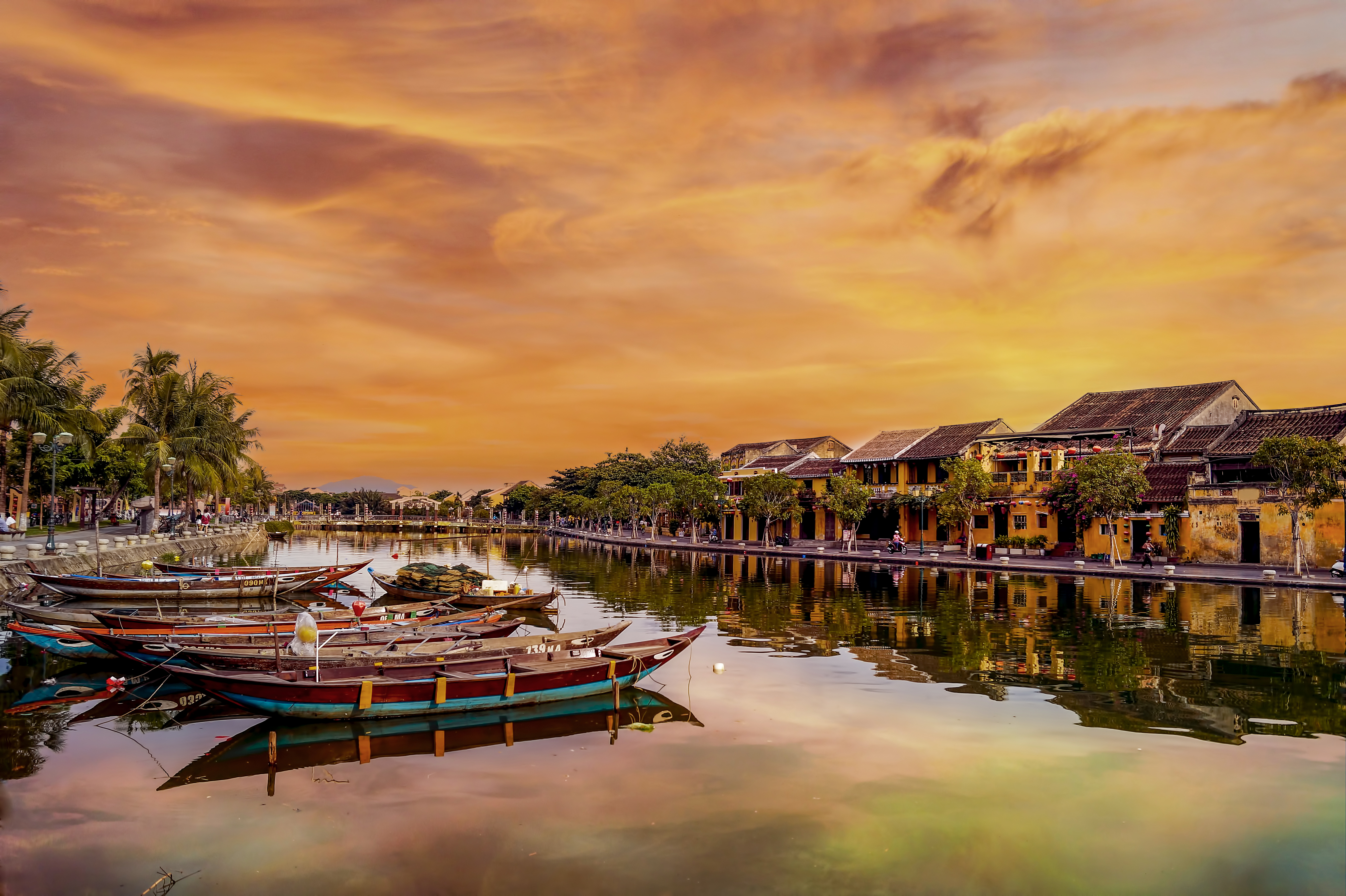 boats on the water with buildings and trees