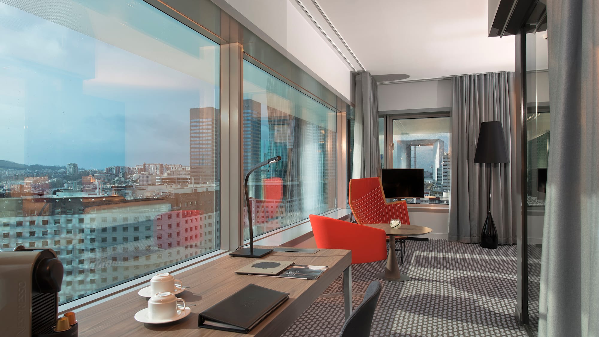 a room with a table and chairs and a window