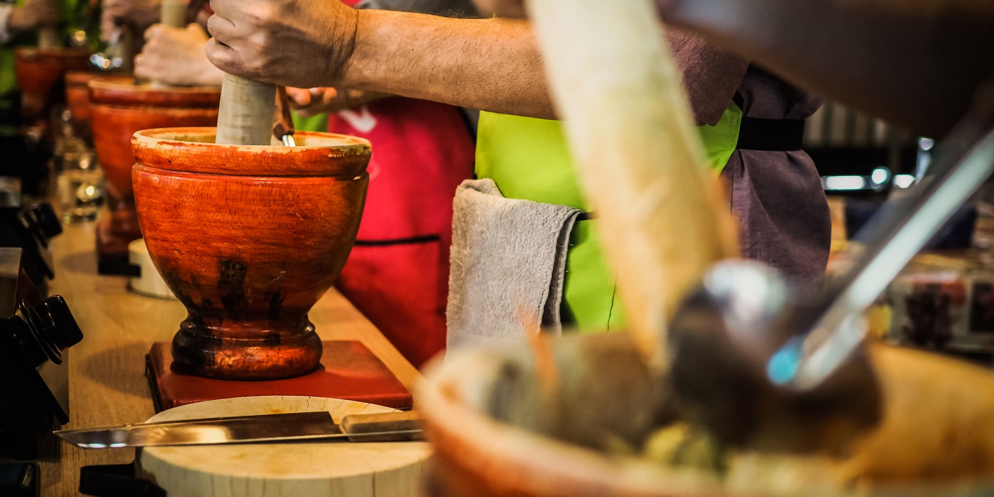 a group of people using mortars