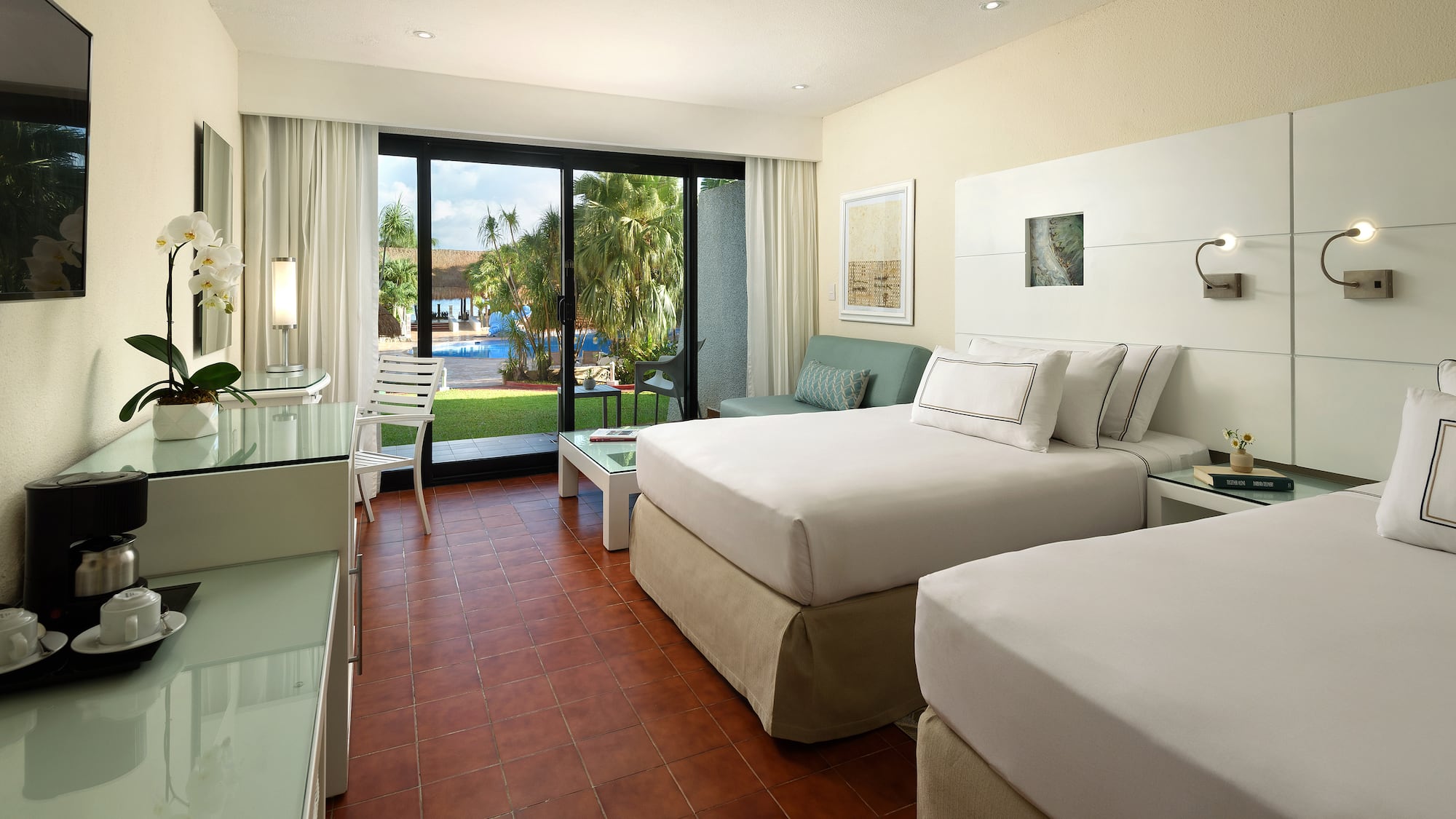 a room with two beds and a glass door