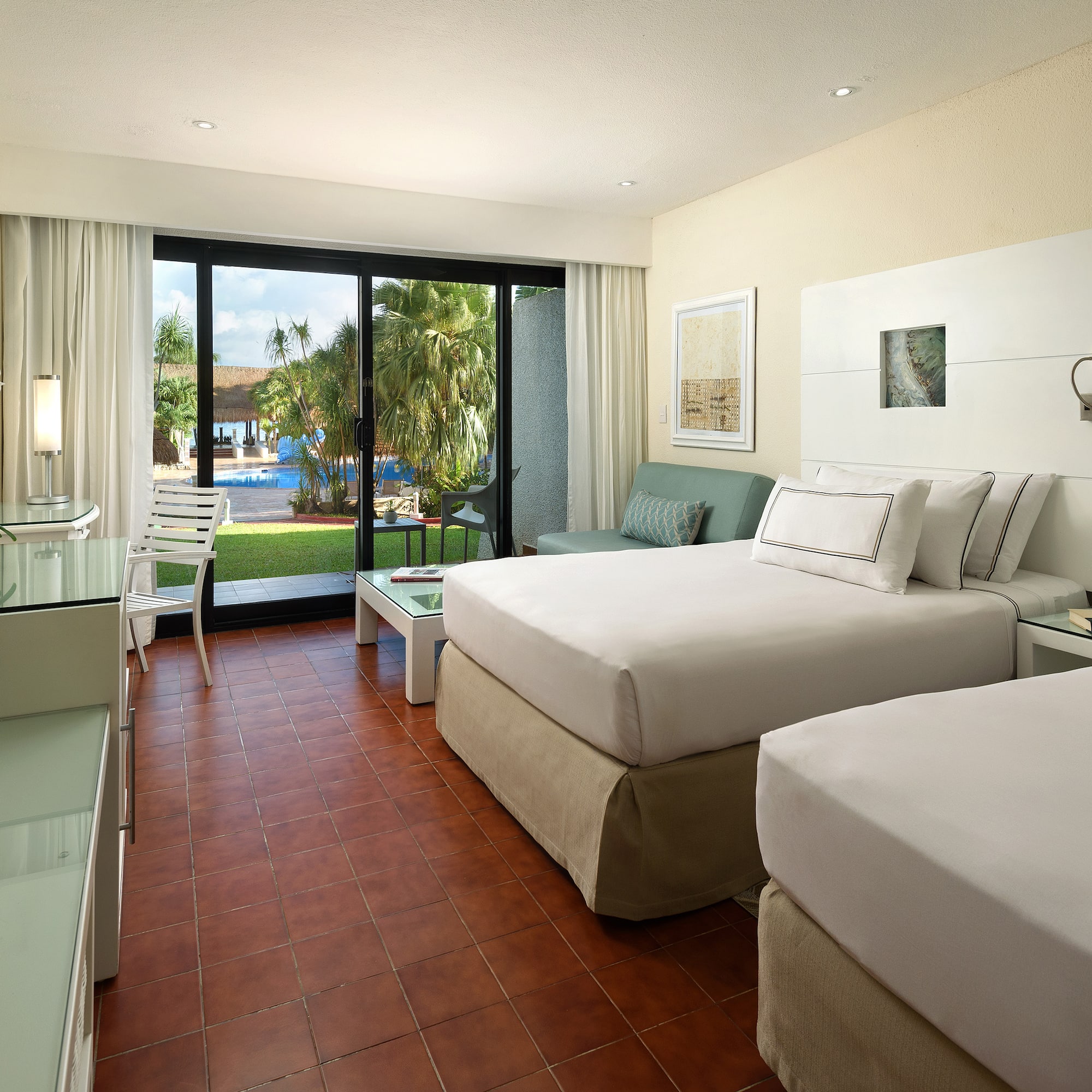 a room with two beds and a glass door