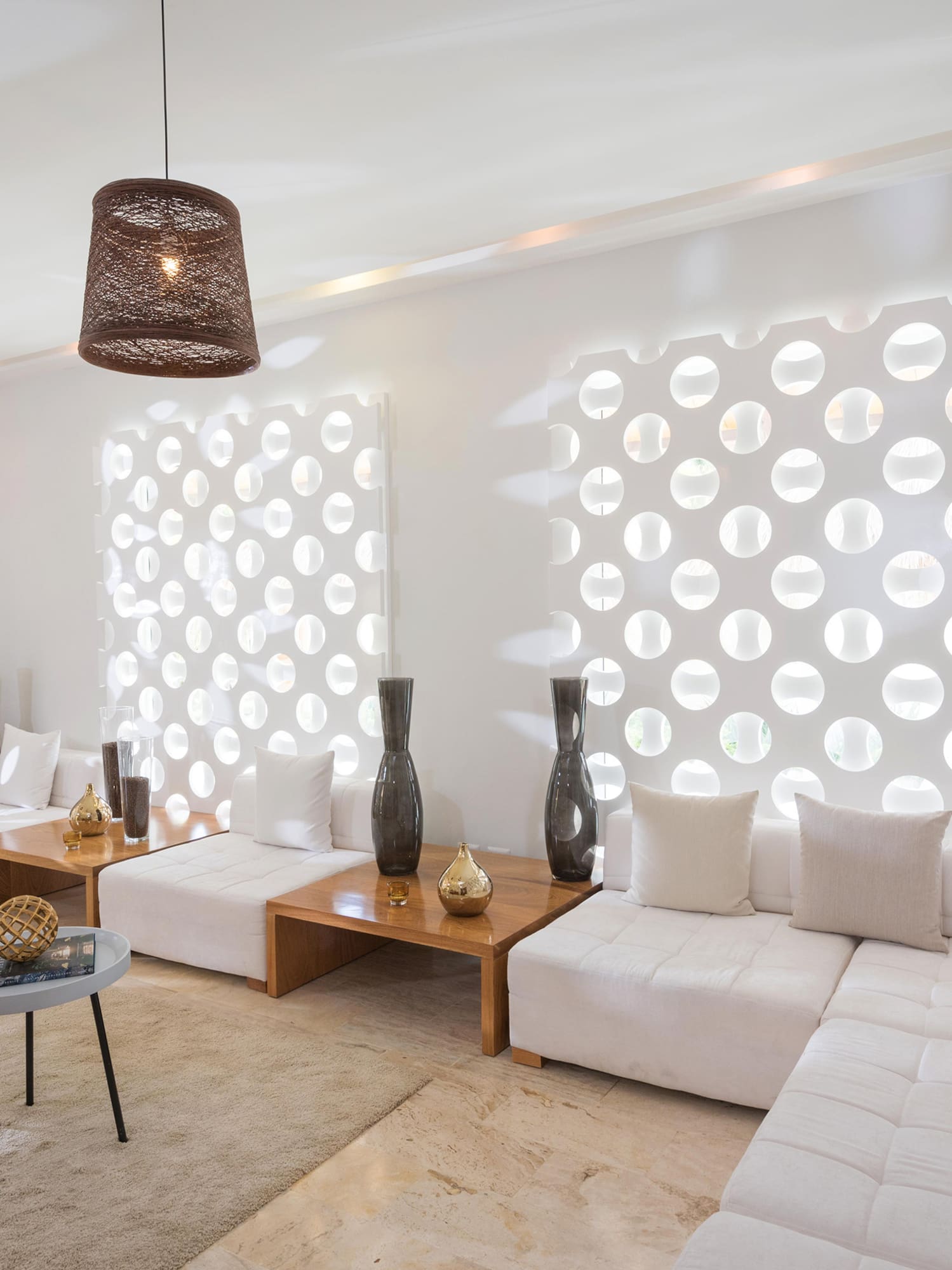 a room with white furniture and brown lamps