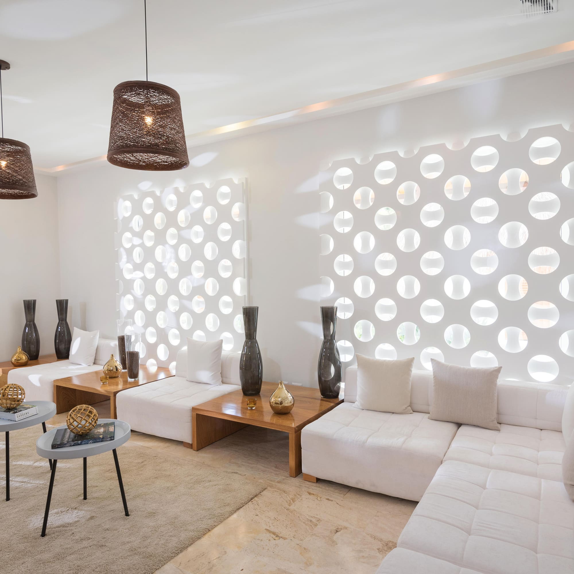 a room with white furniture and brown lamps