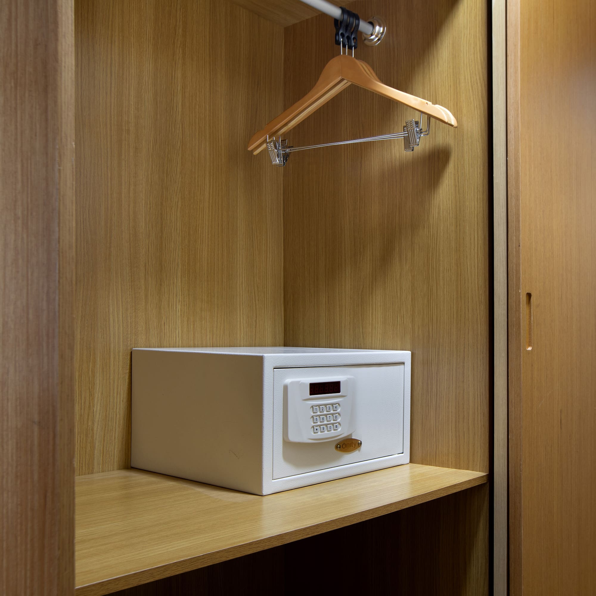 a white safe on a wooden shelf
