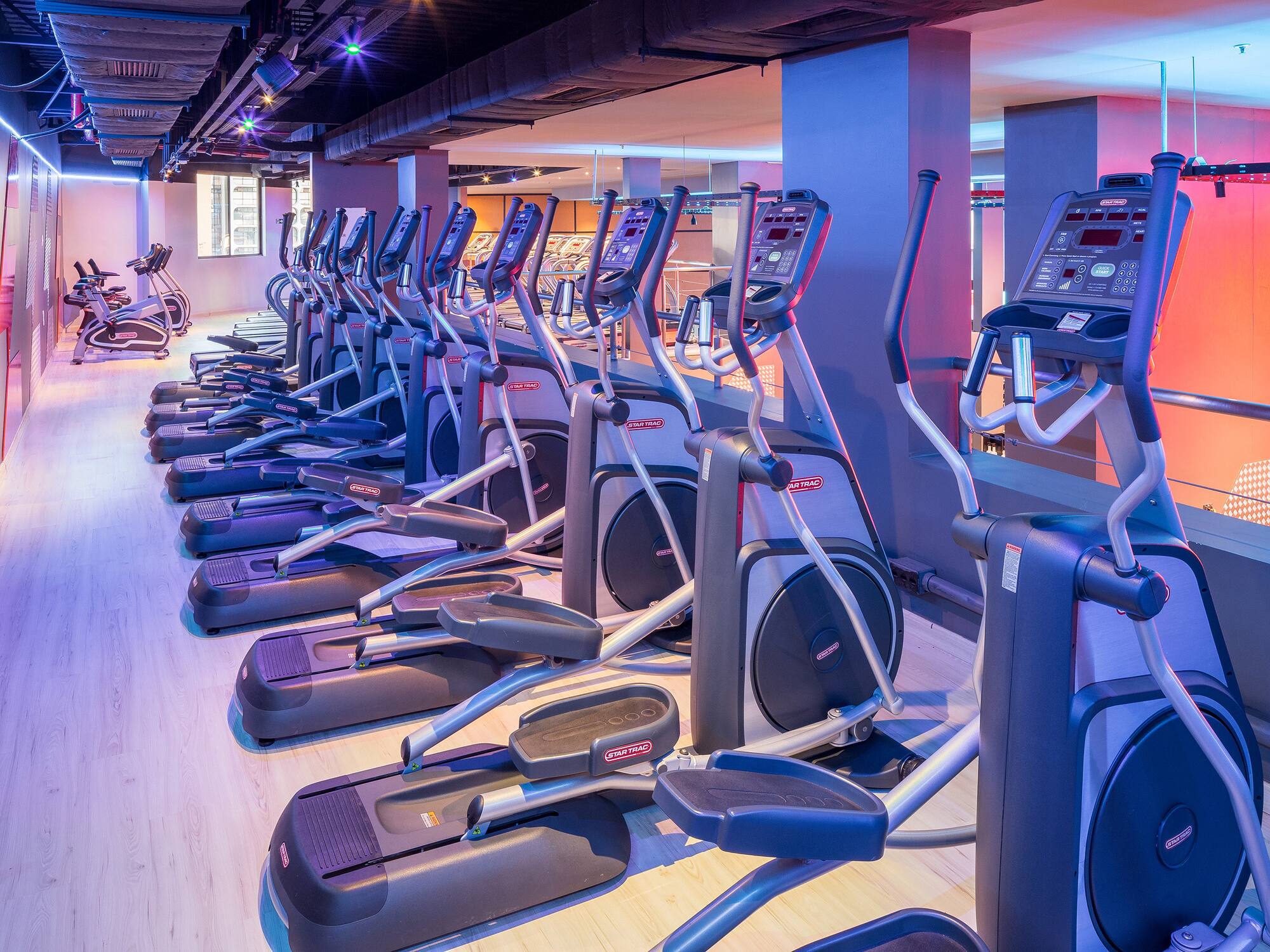 a group of exercise machines in a gym