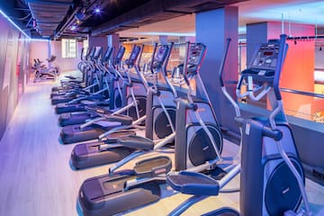 a group of exercise machines in a gym