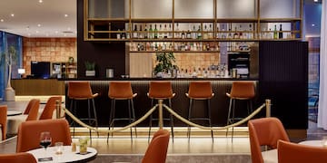 a bar with chairs and a bar with a rope around it