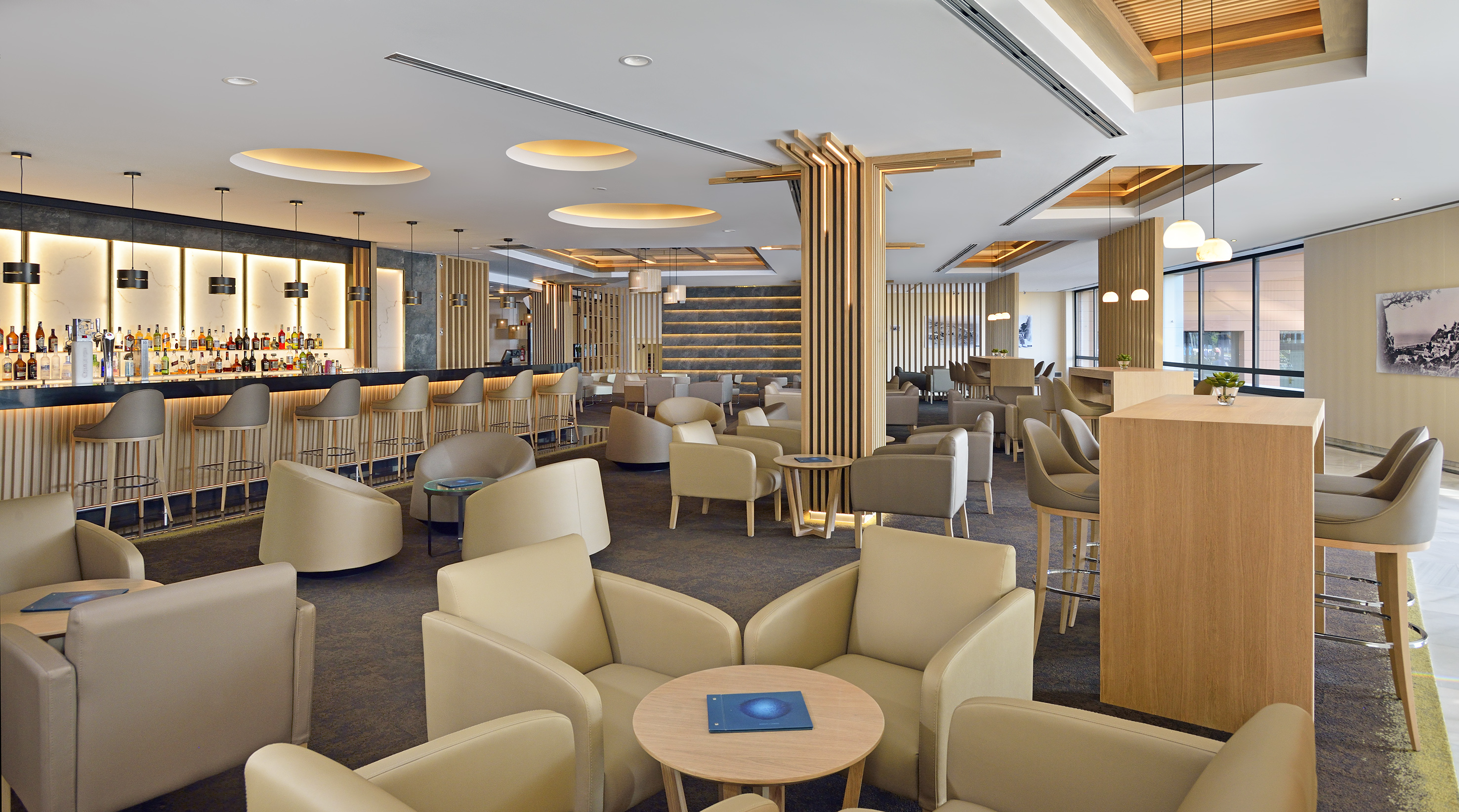 Modern hotel lobby bar and lounge with sleek design, comfortable seating.