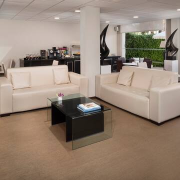 a room with white couches and a glass coffee table