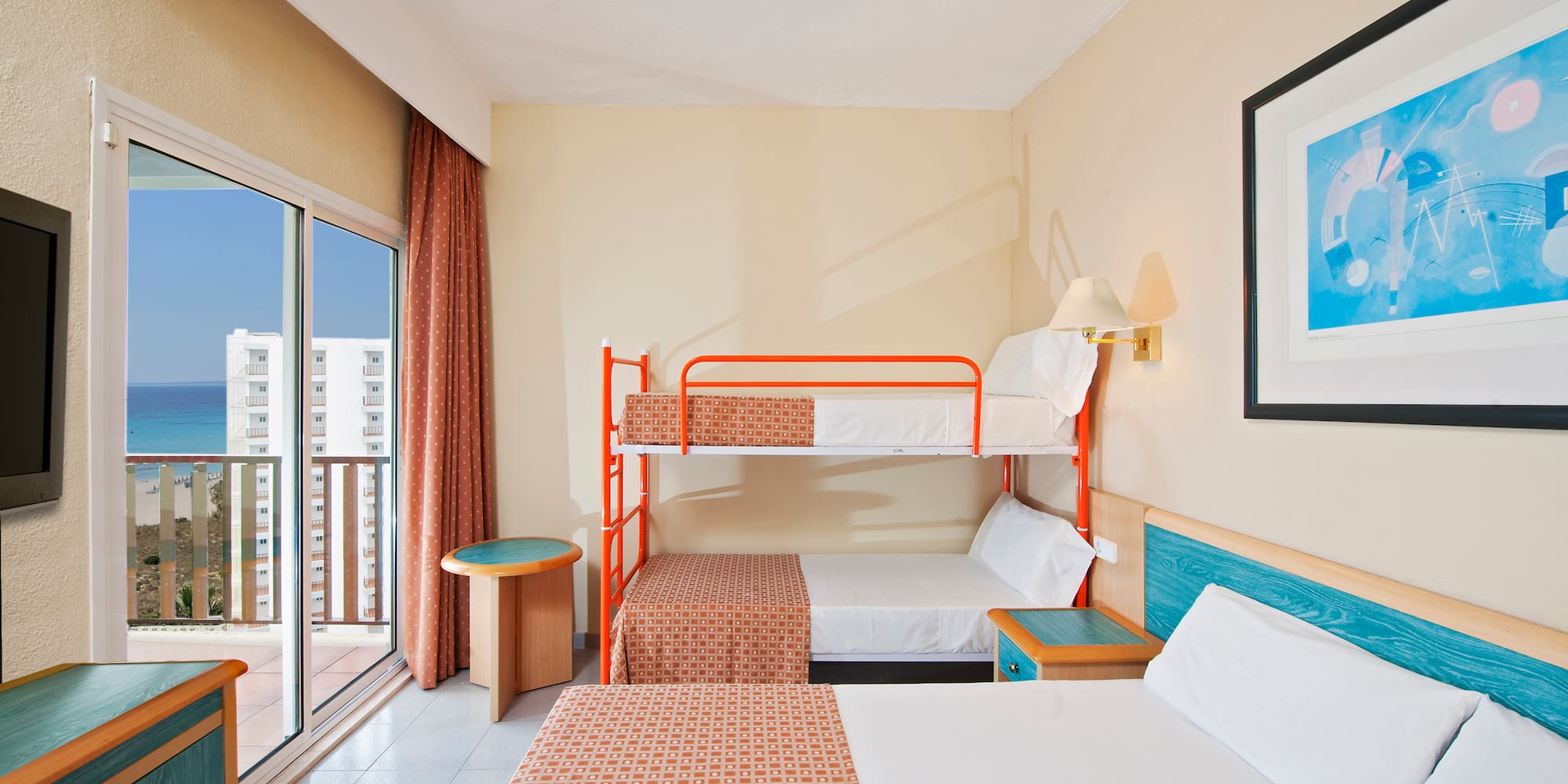 a room with two bunk beds and a glass door