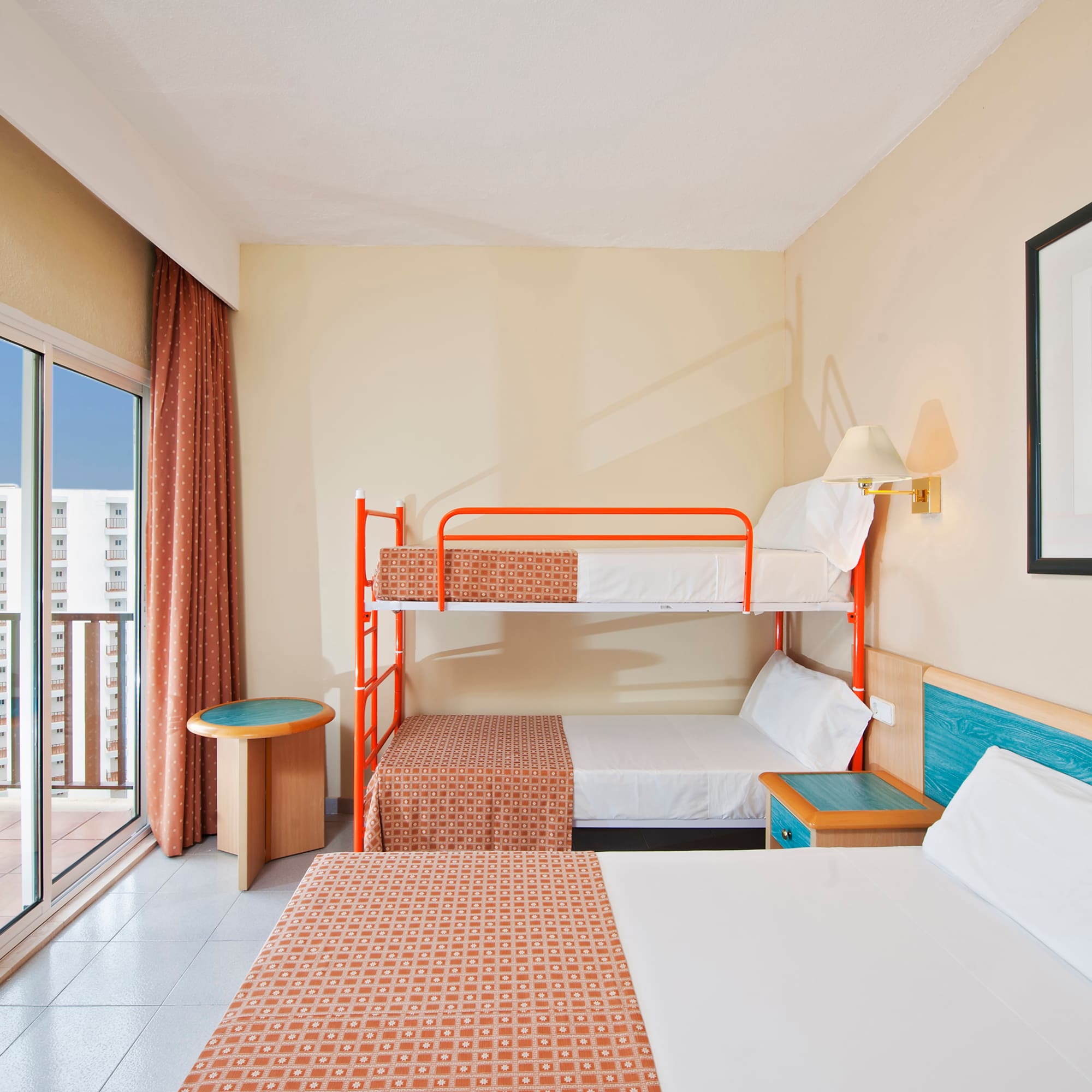 a room with two bunk beds and a glass door