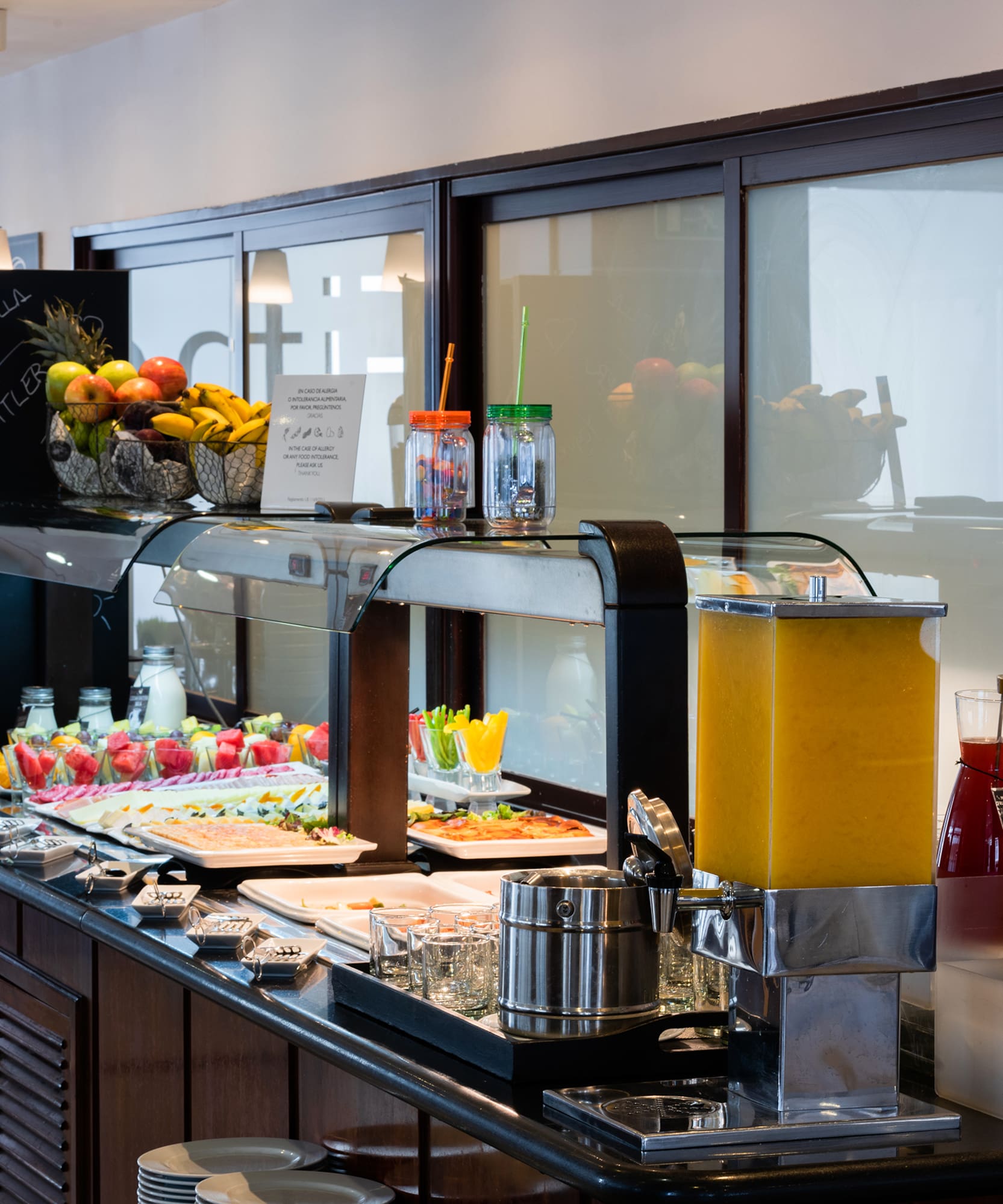 a buffet with fruit and drinks