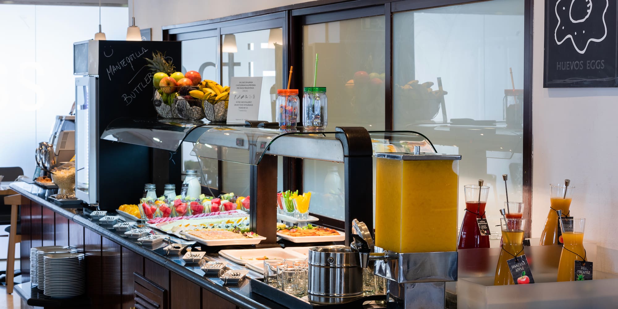 a buffet with fruit and drinks