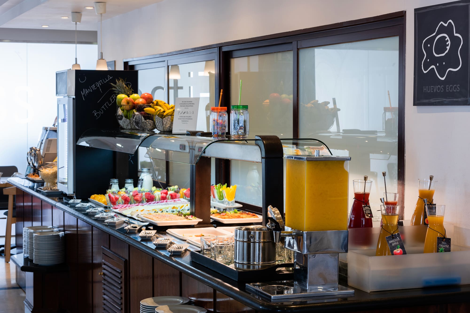 a buffet with fruit and drinks