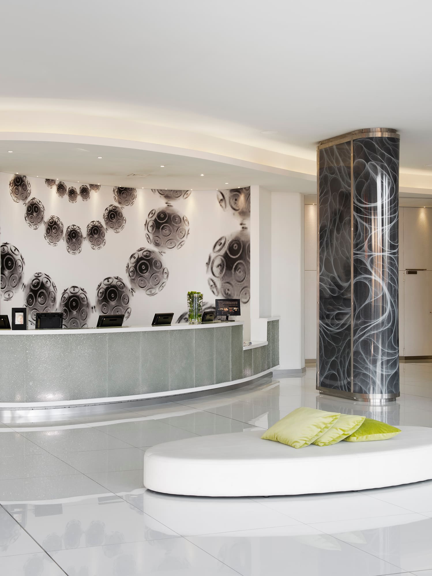 a lobby with a round white and black reception desk