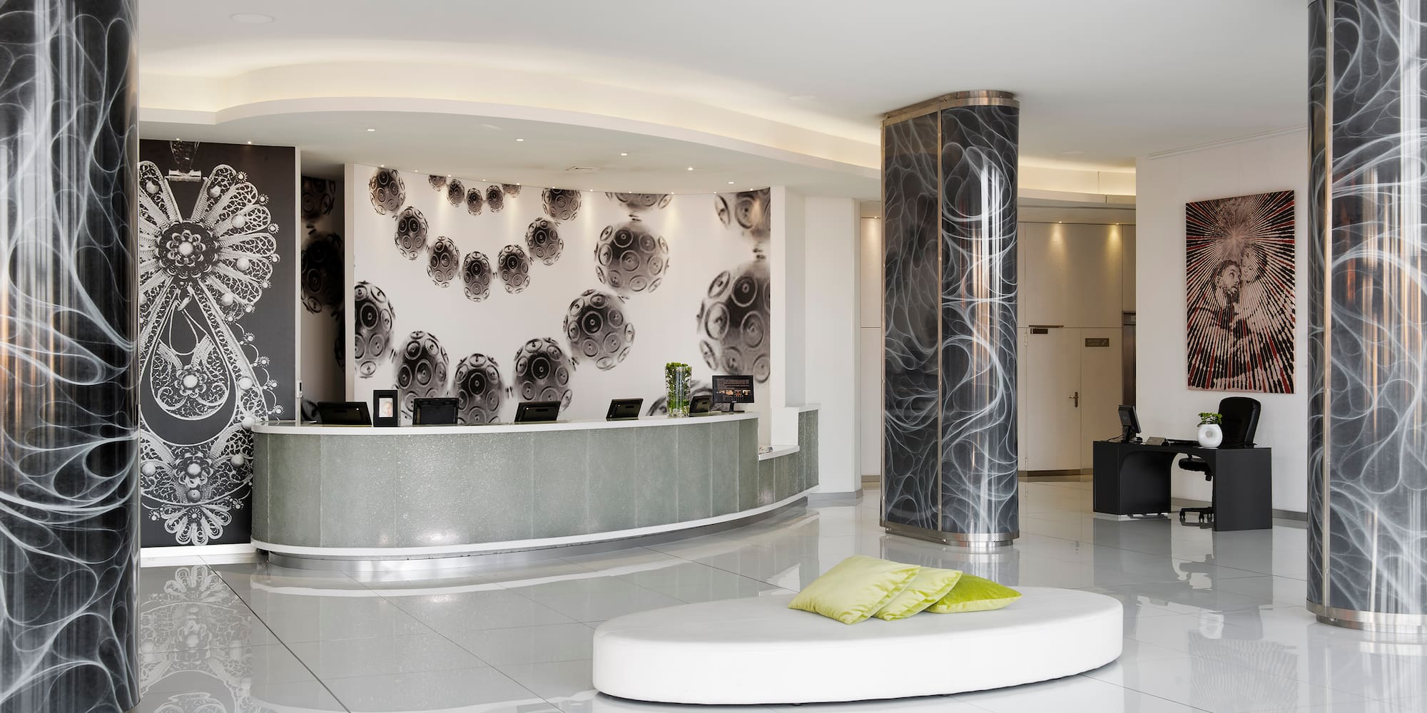 a lobby with a round white and black reception desk