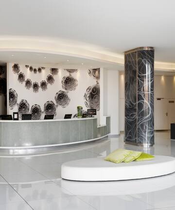 a lobby with a round white and black reception desk