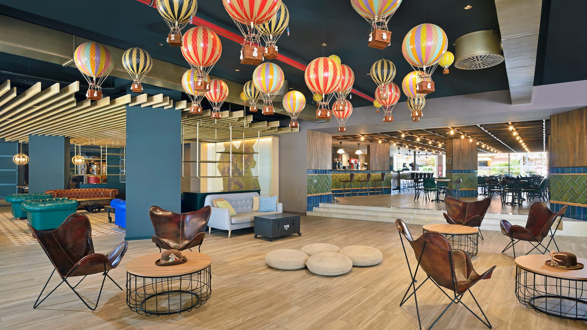 a room with a large group of hot air balloons from the ceiling