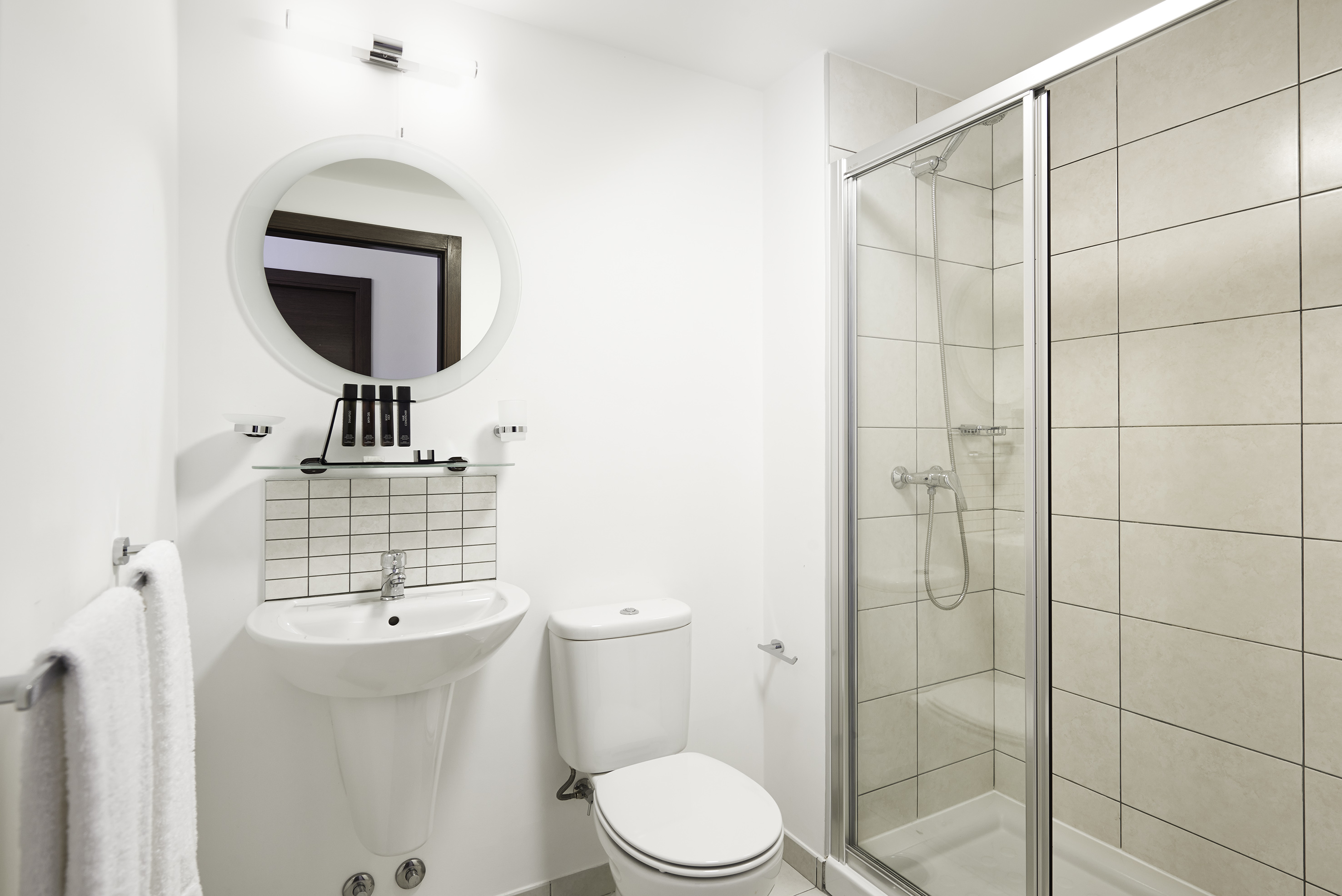 a bathroom with a shower and toilet