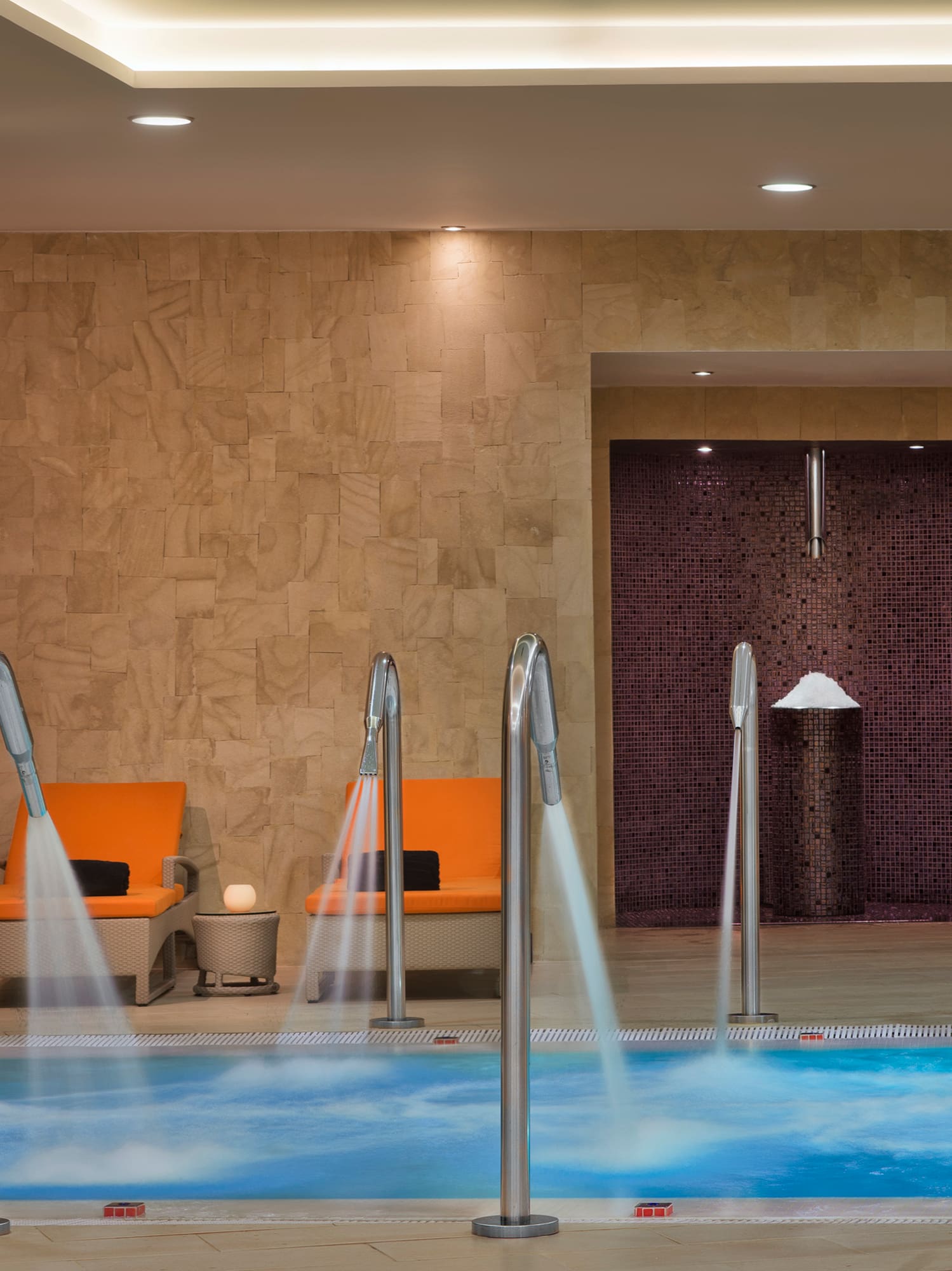 a pool with water running down the water