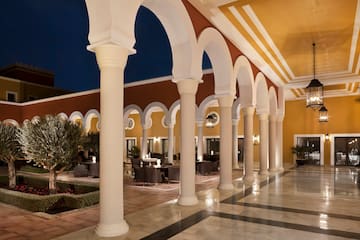 a building with white columns and a yellow ceiling
