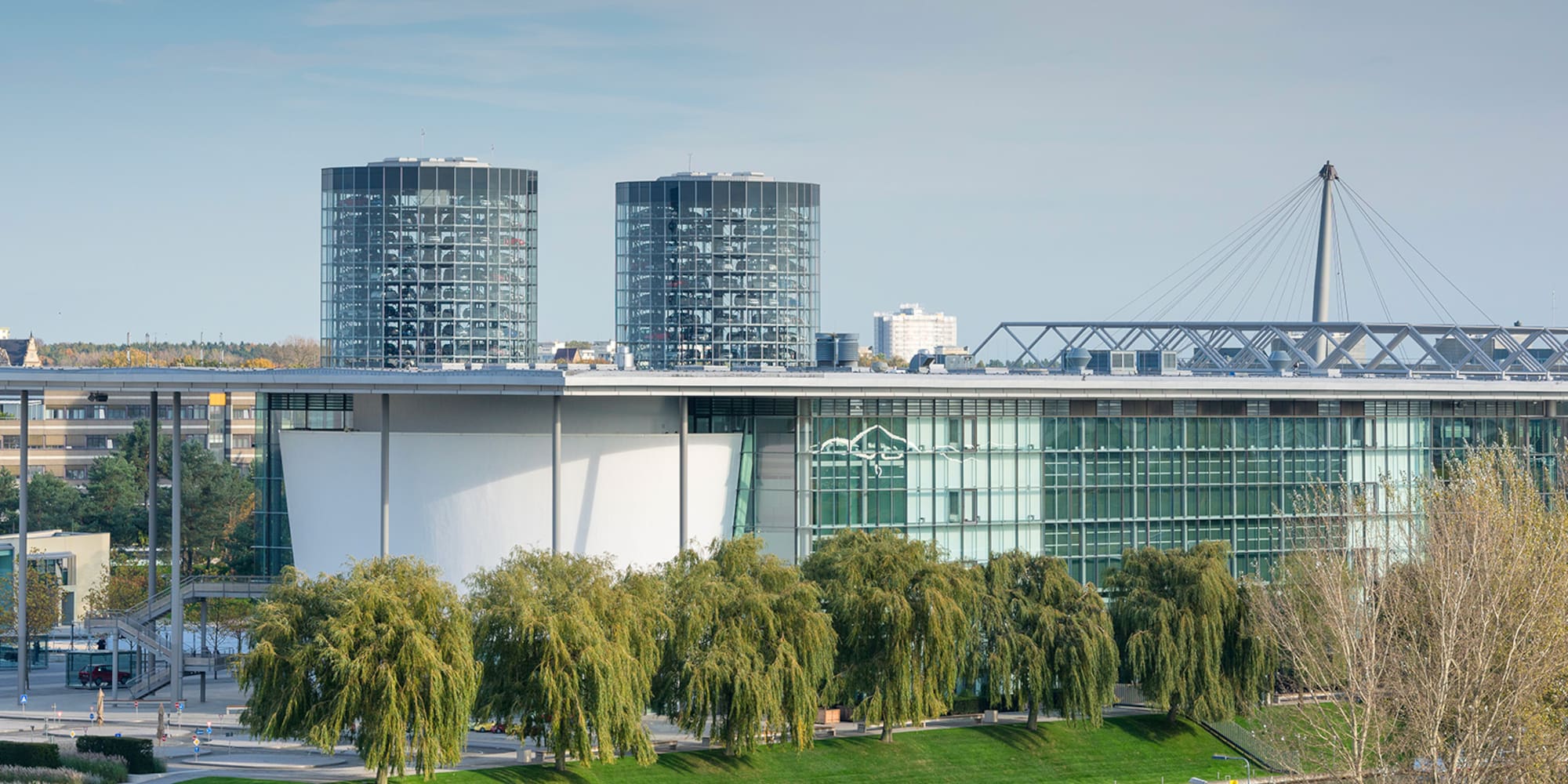 a building with glass windows and trees