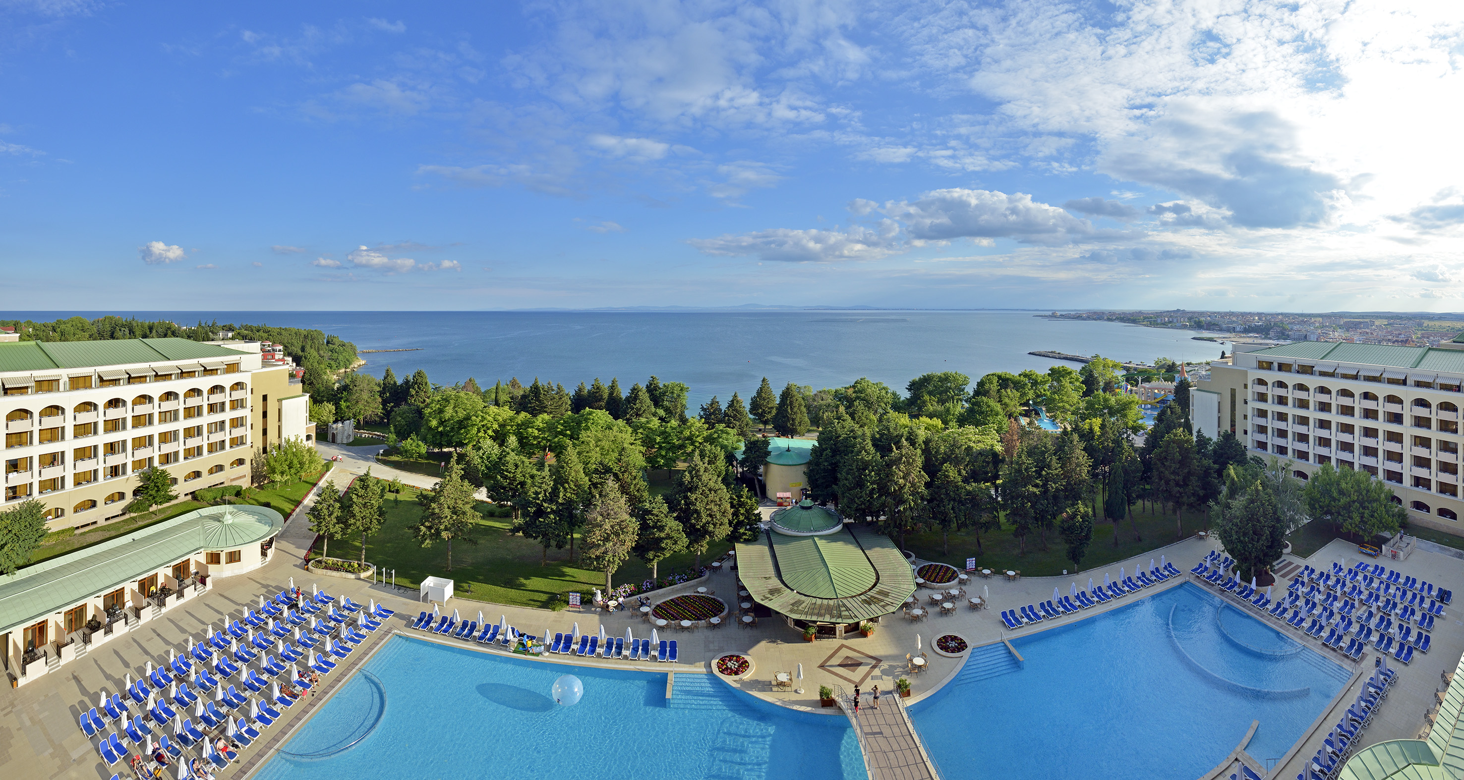 a pool with trees and a body of water
