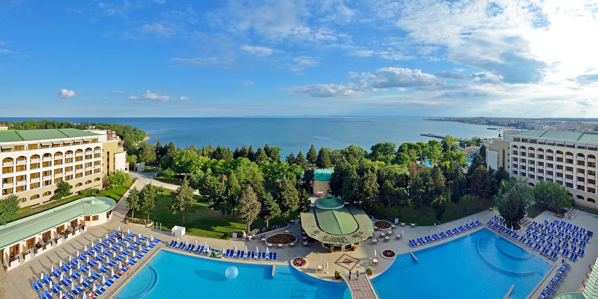 a pool with trees and a body of water