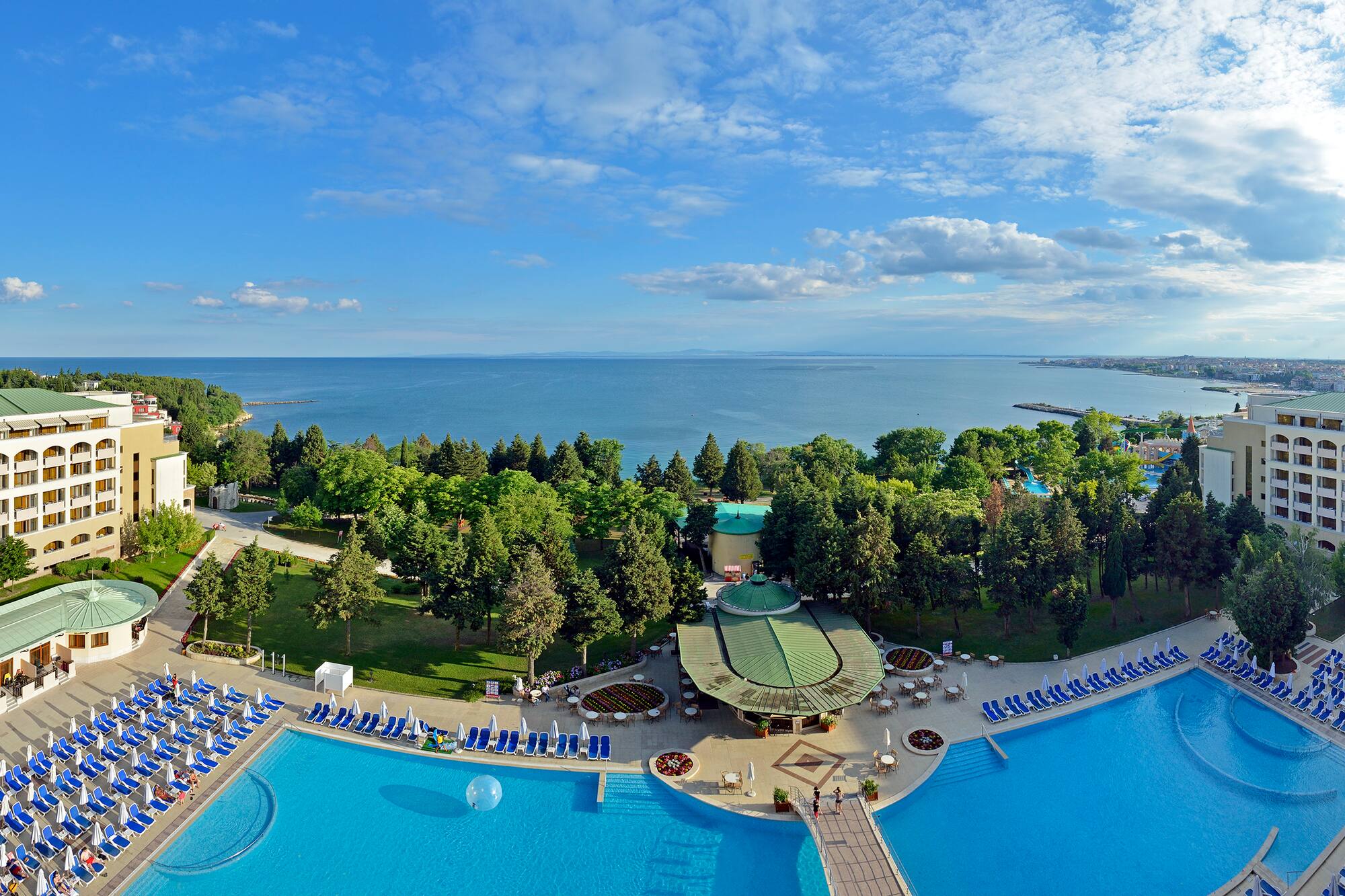 a pool with trees and a body of water