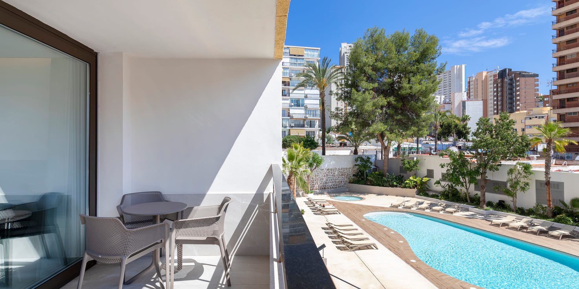 a pool and chairs on a balcony