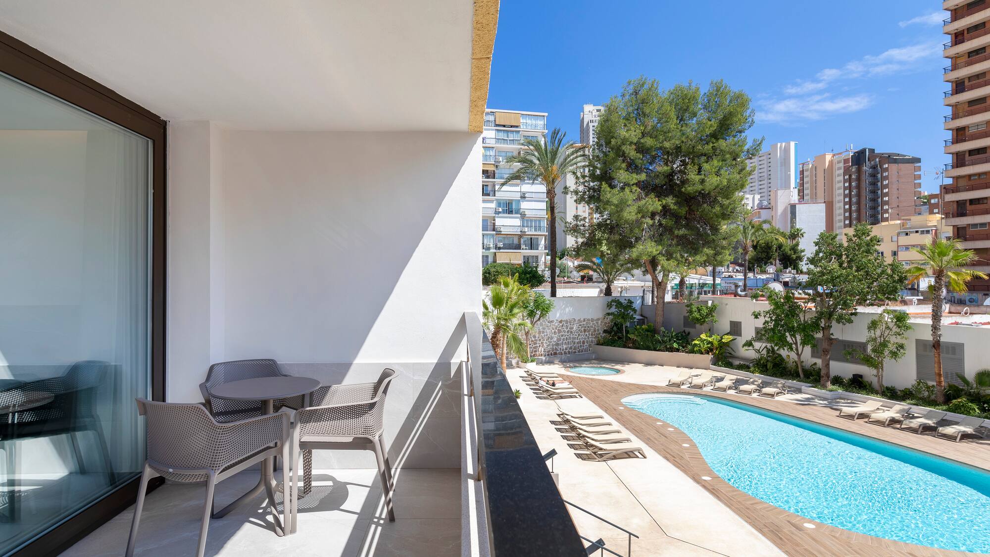 a pool and chairs on a balcony