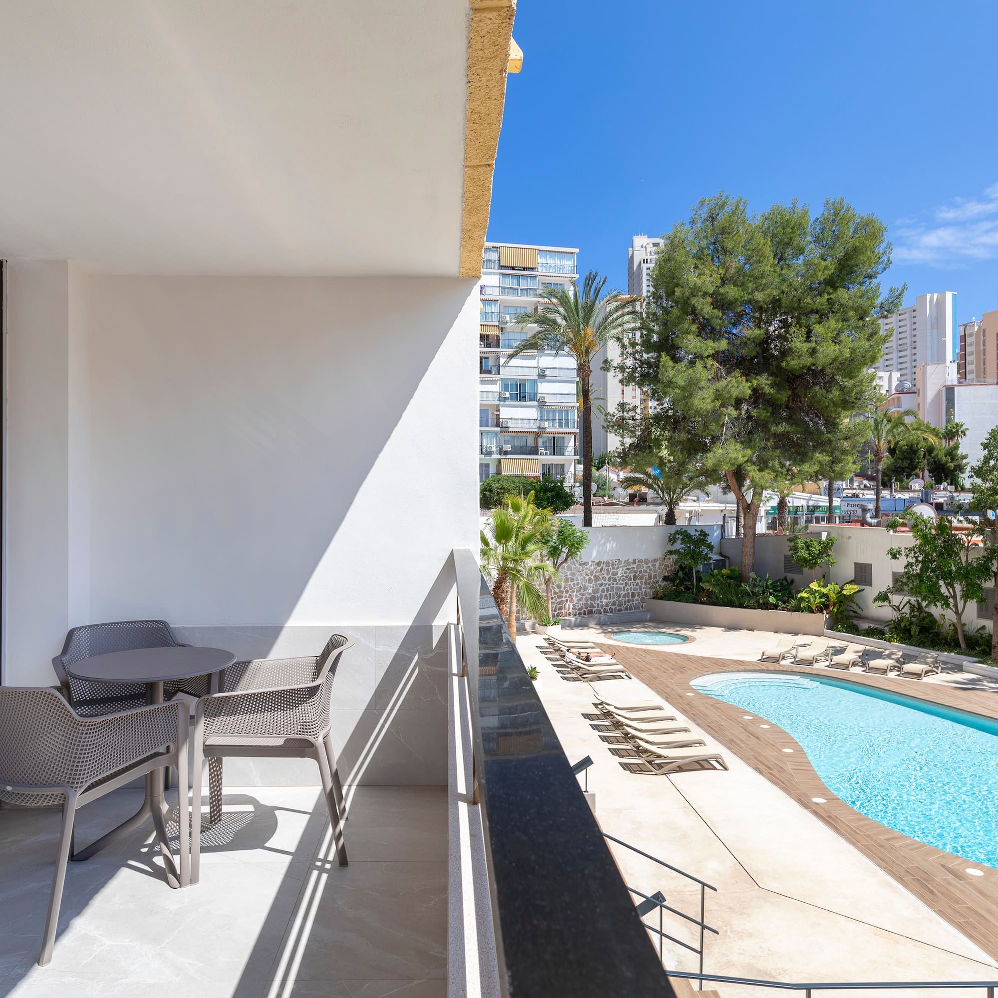 a pool and chairs on a balcony
