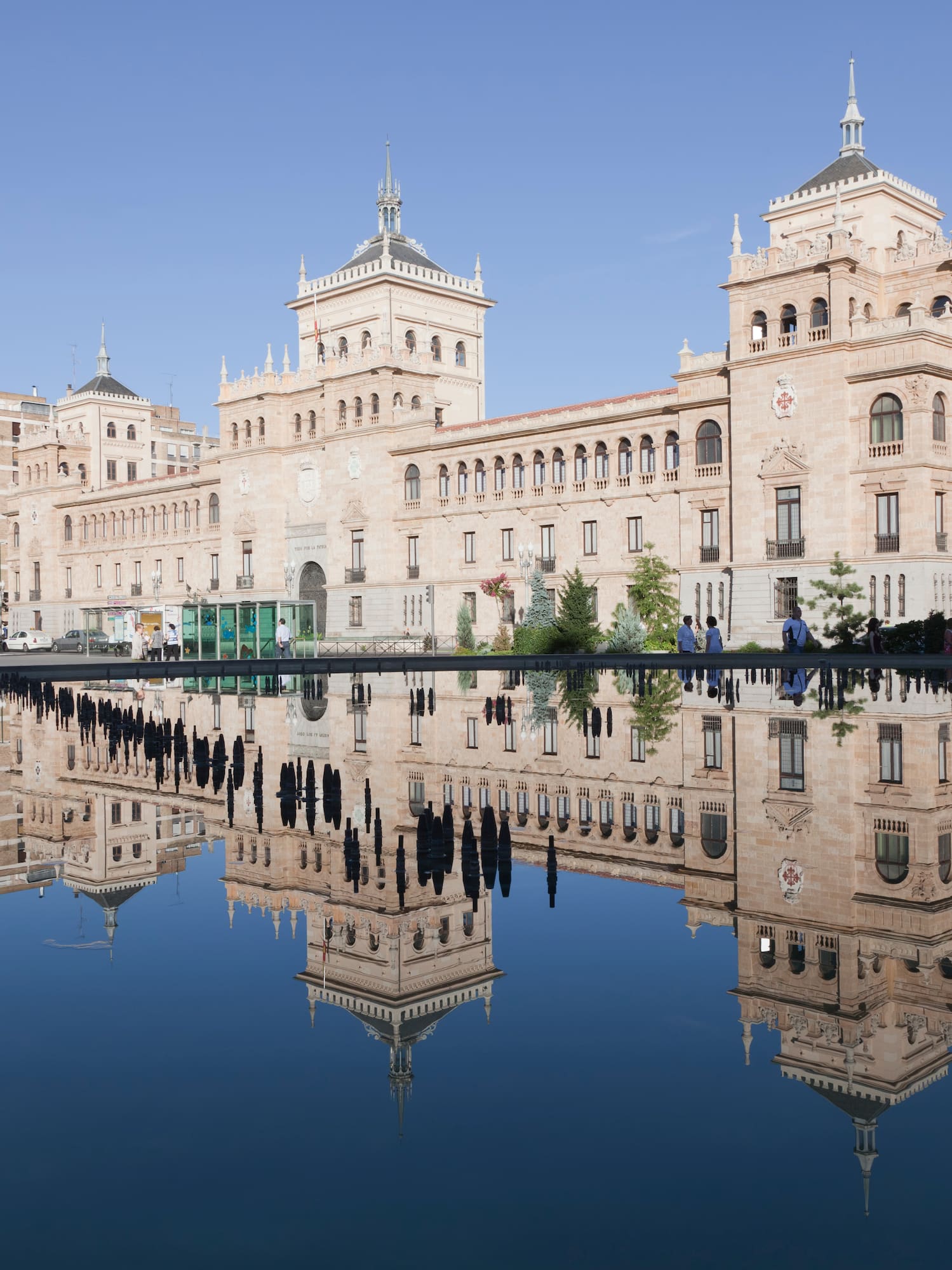 a building with a statue and a body of water