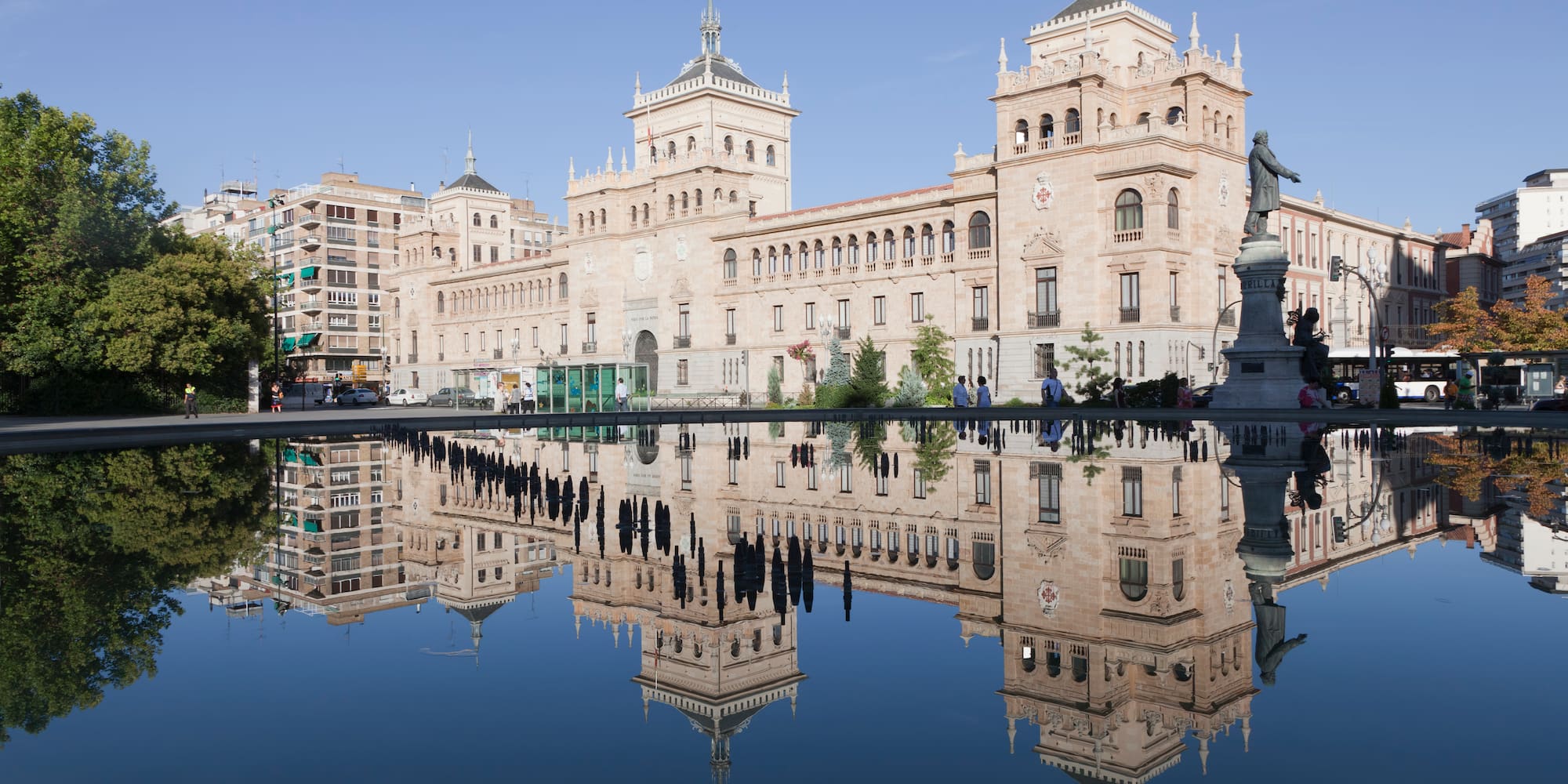 a building with a statue and a body of water