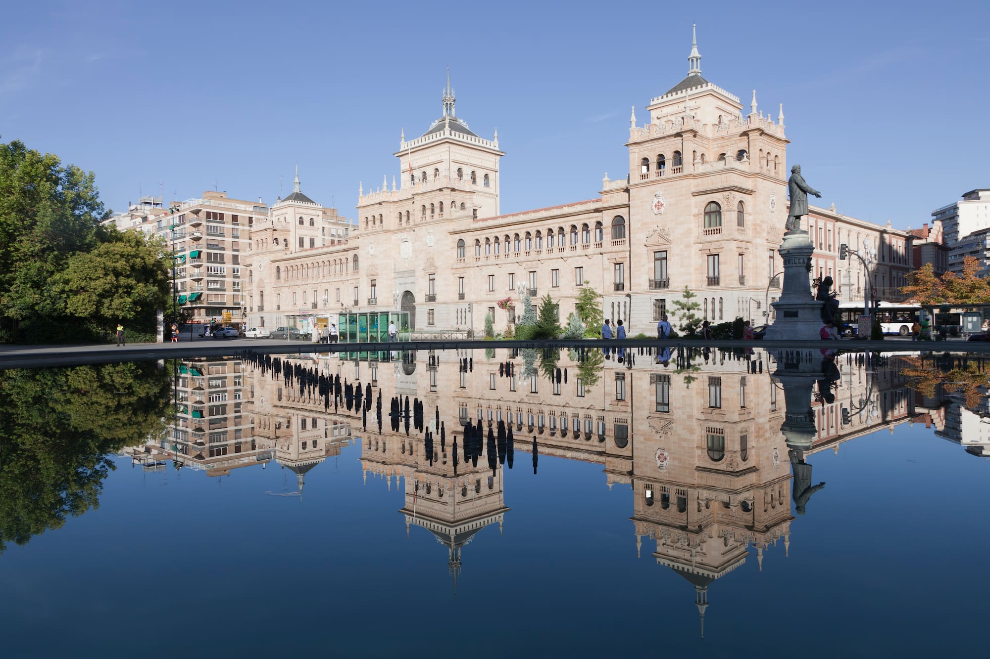 a building with a statue and a body of water