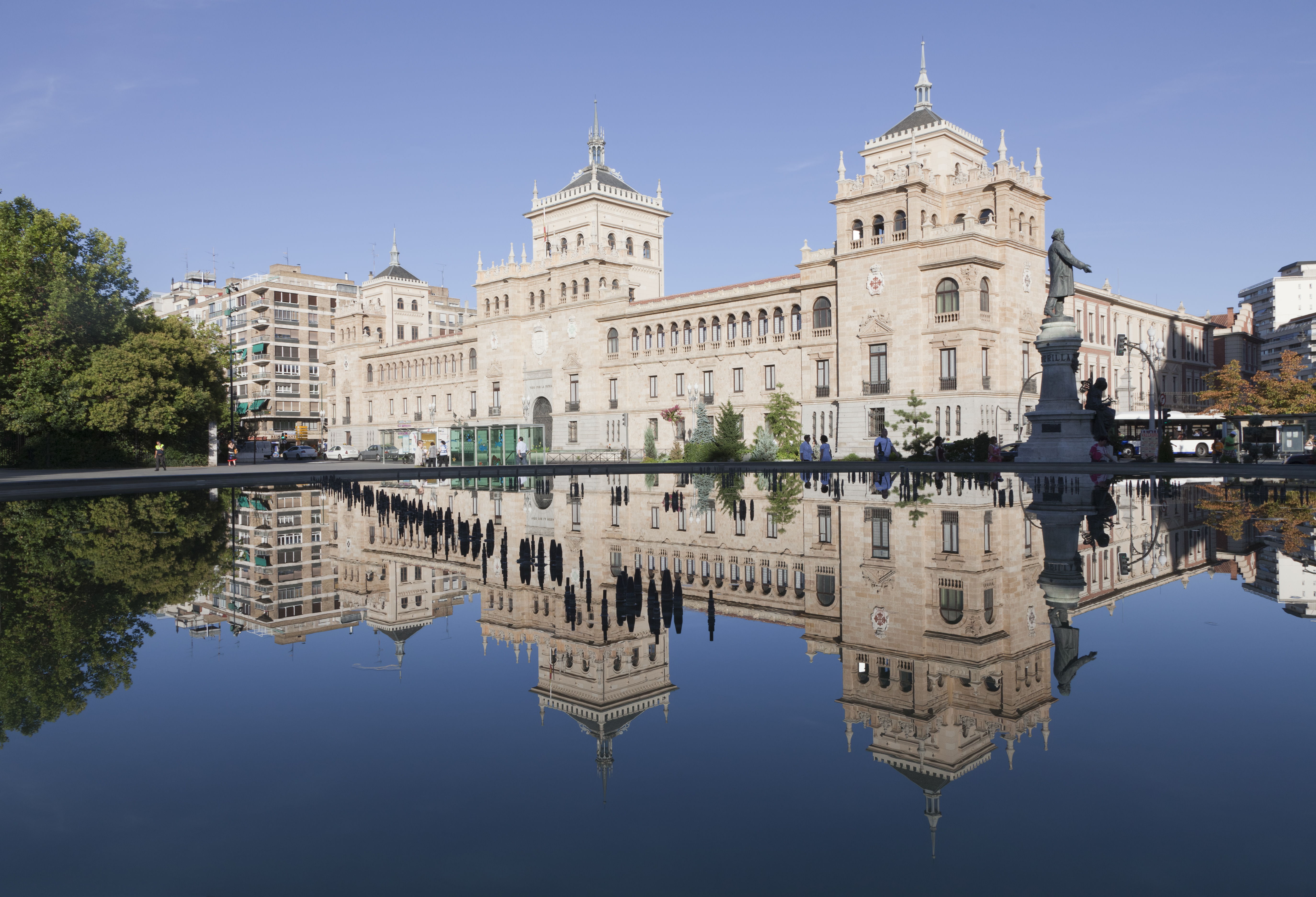 a building with a statue and a body of water