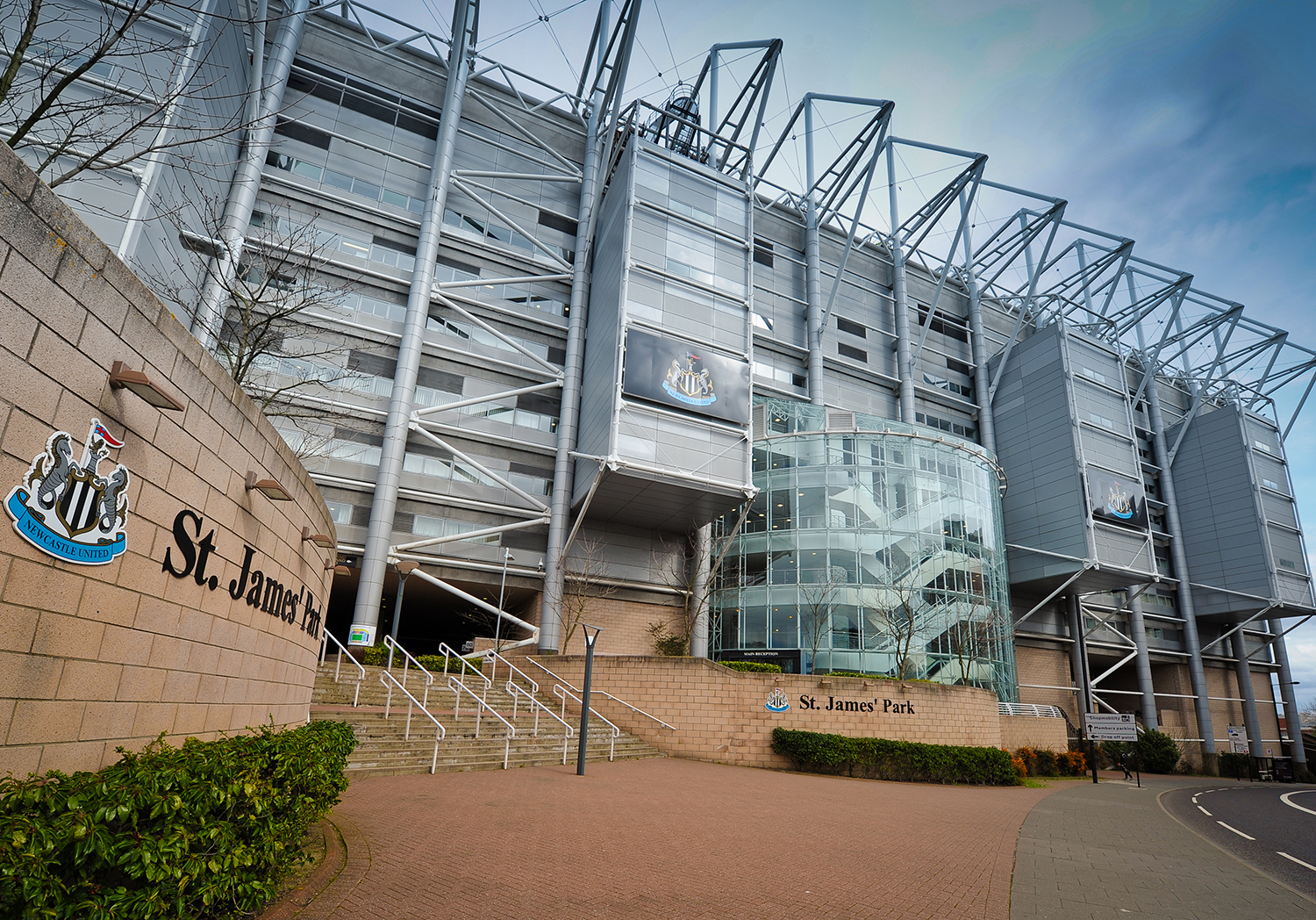 Modern St. James' Park stadium, Newcastle United crest visible.