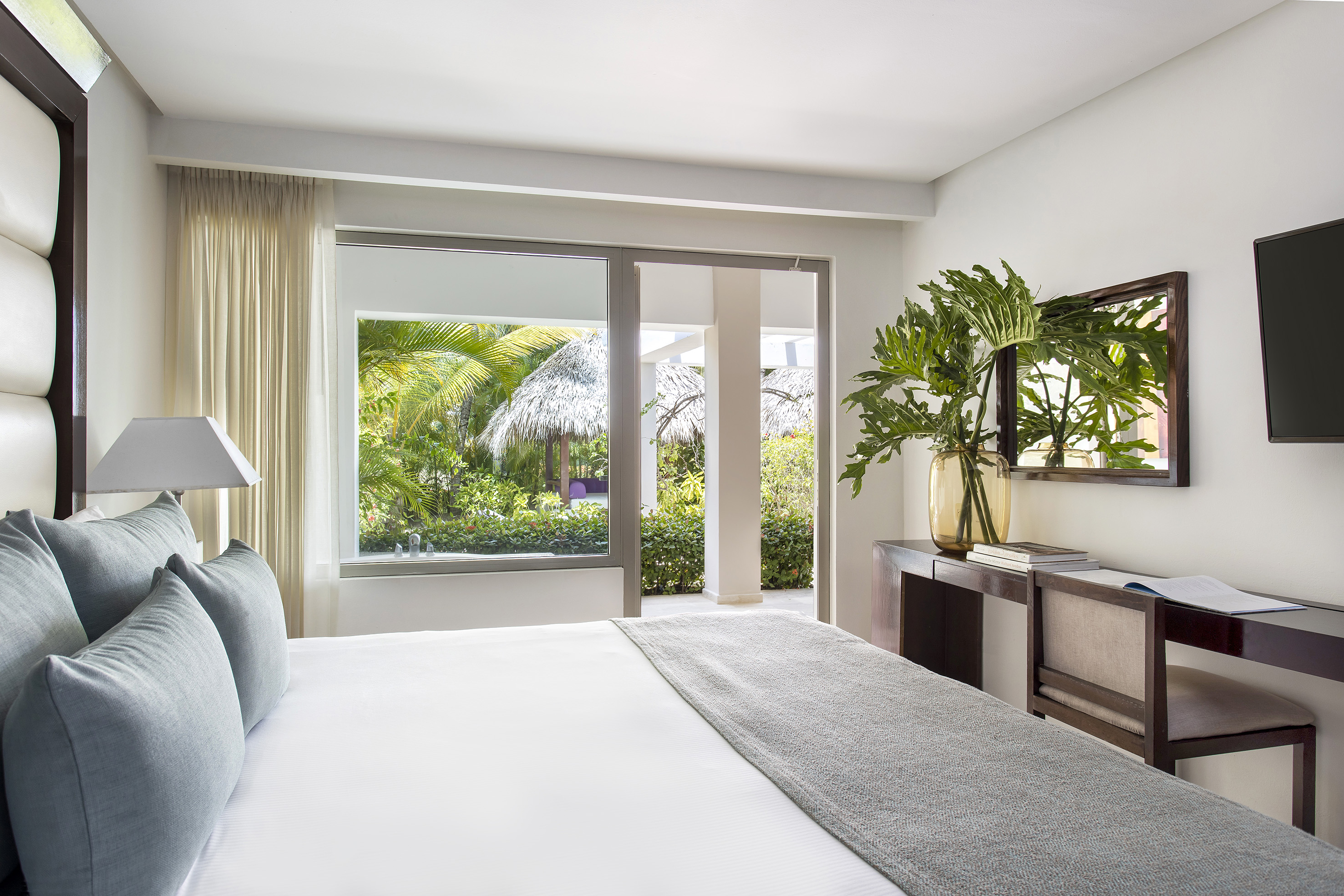 a bedroom with a bed and a mirror