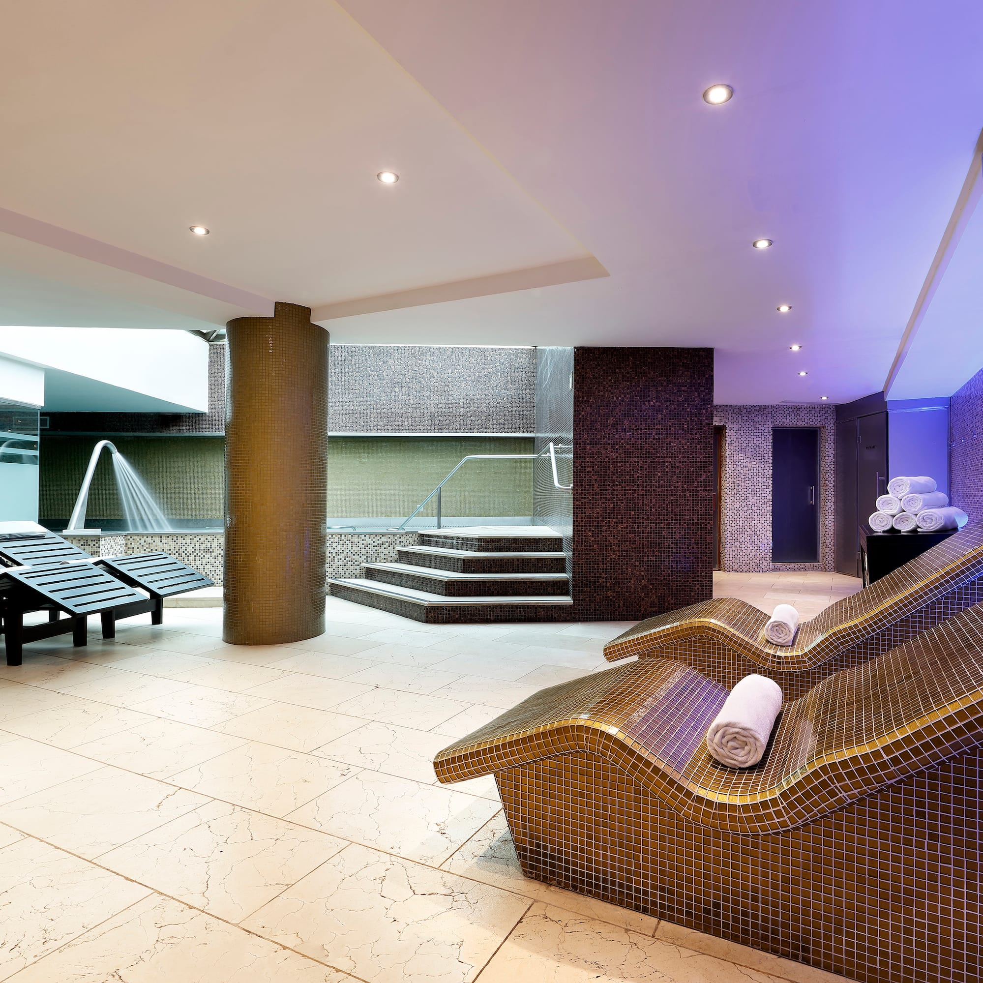 a room with chairs and a shower