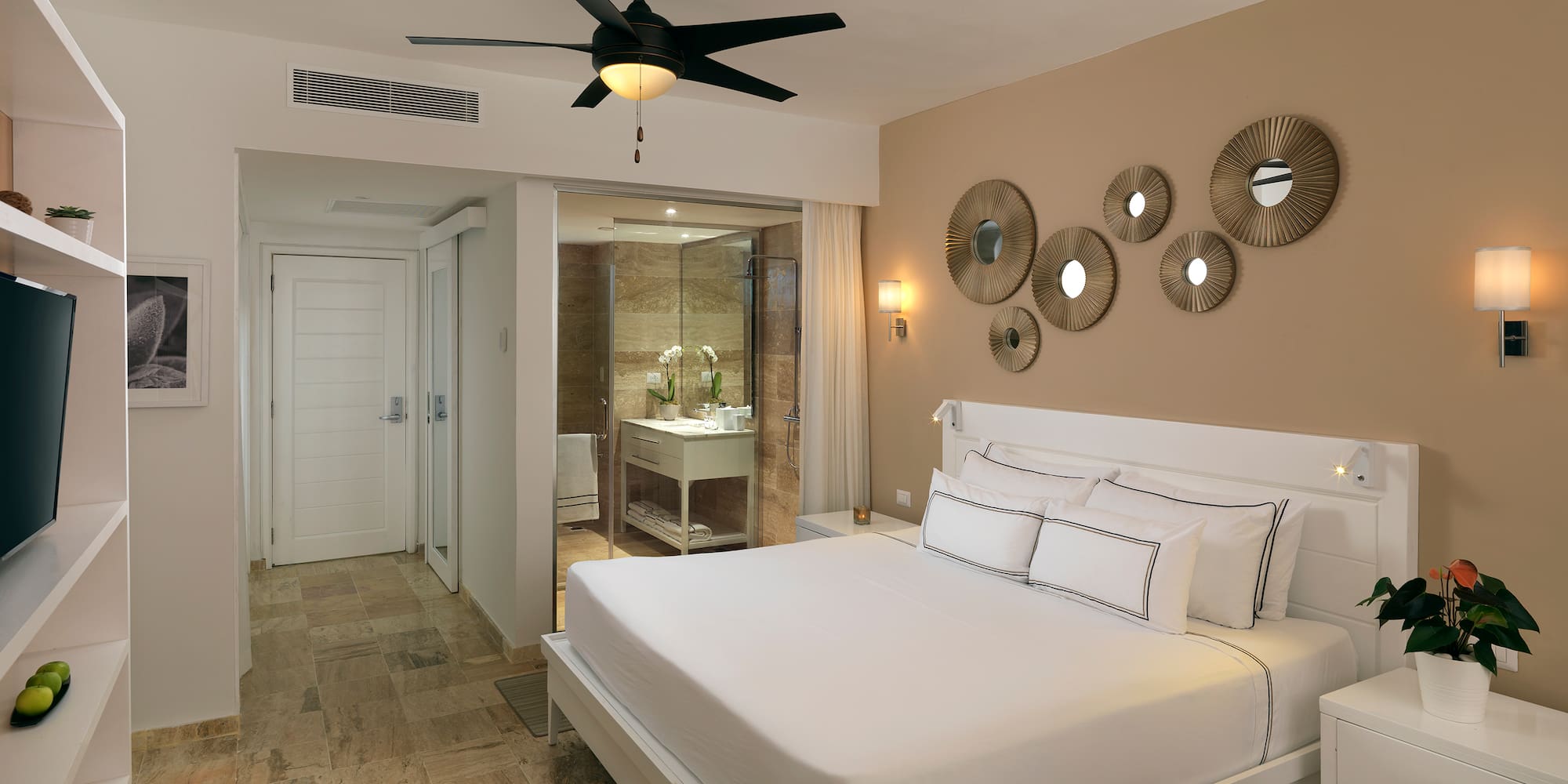 a bedroom with a ceiling fan and a bed