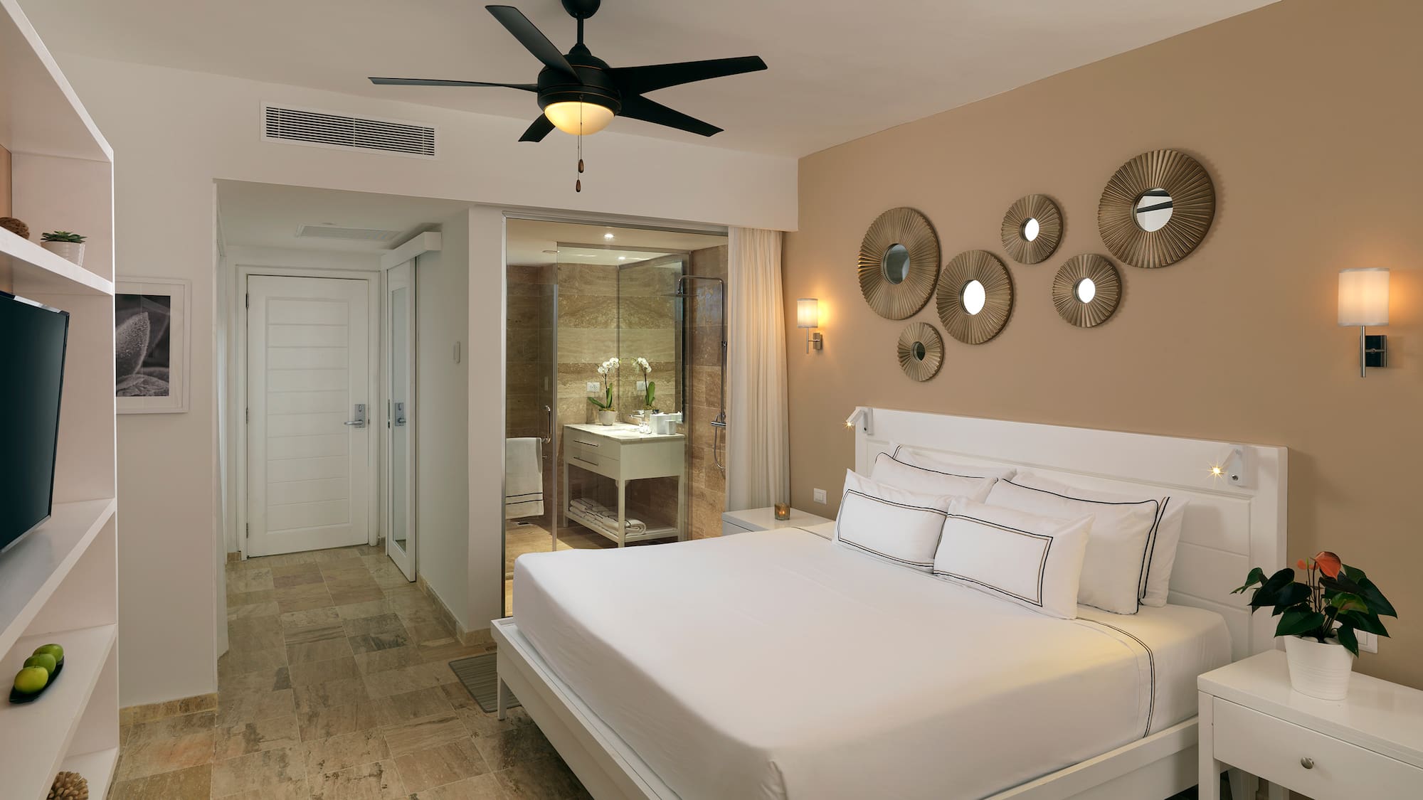 a bedroom with a ceiling fan and a bed