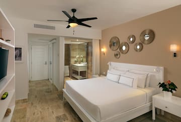a bedroom with a ceiling fan and a bed