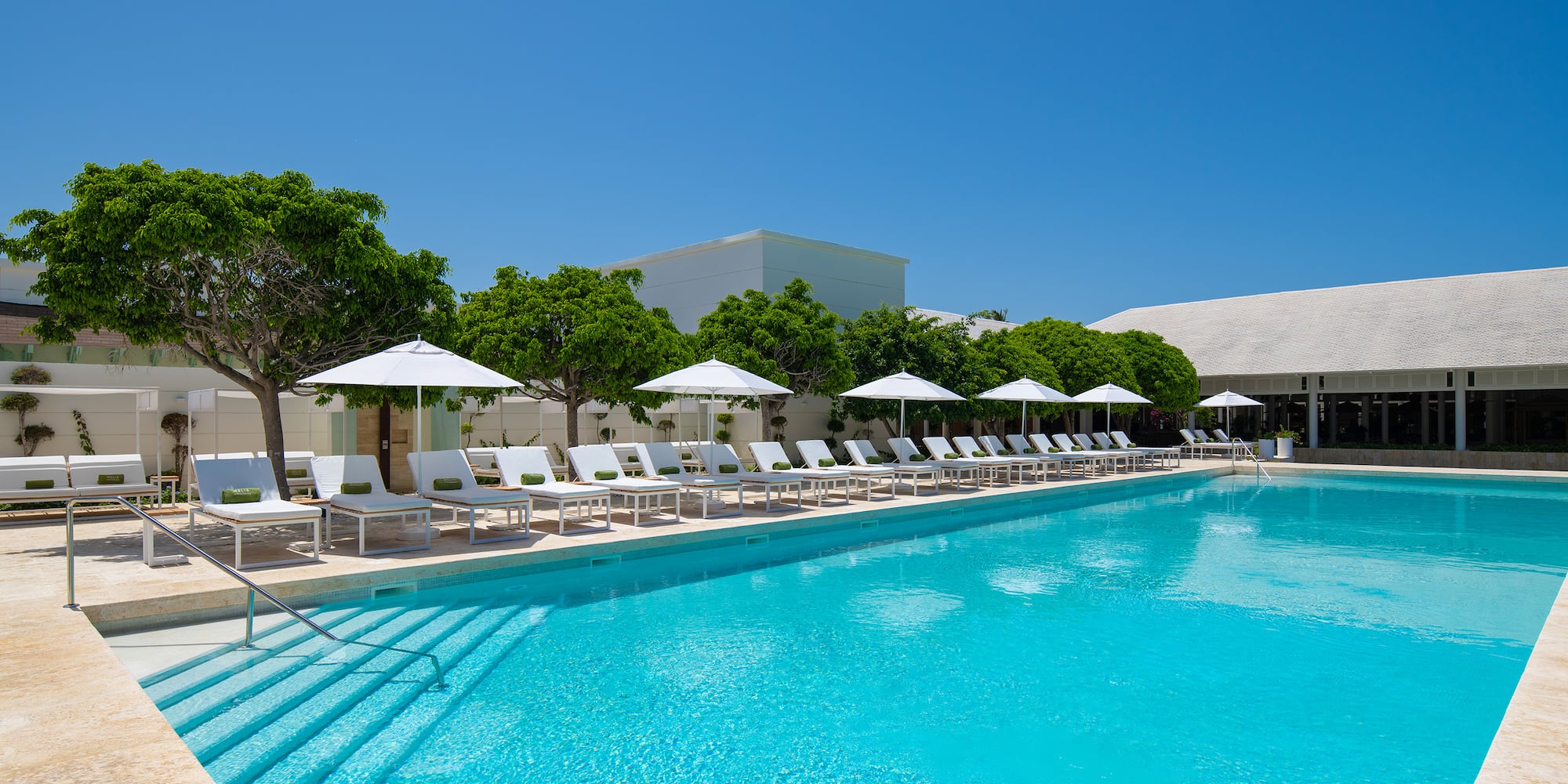 a pool with chairs and umbrellas