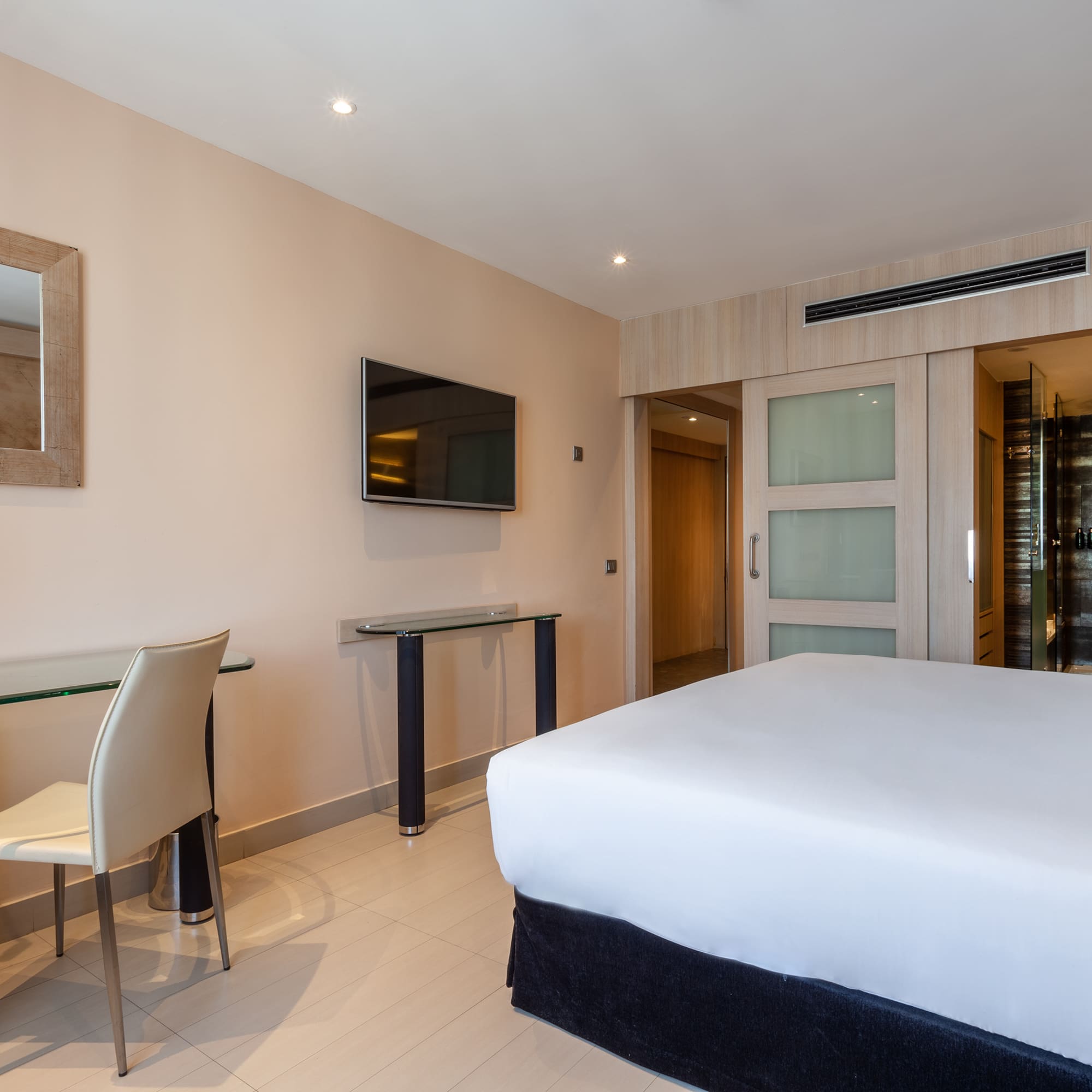 a room with a bed and a table and chairs