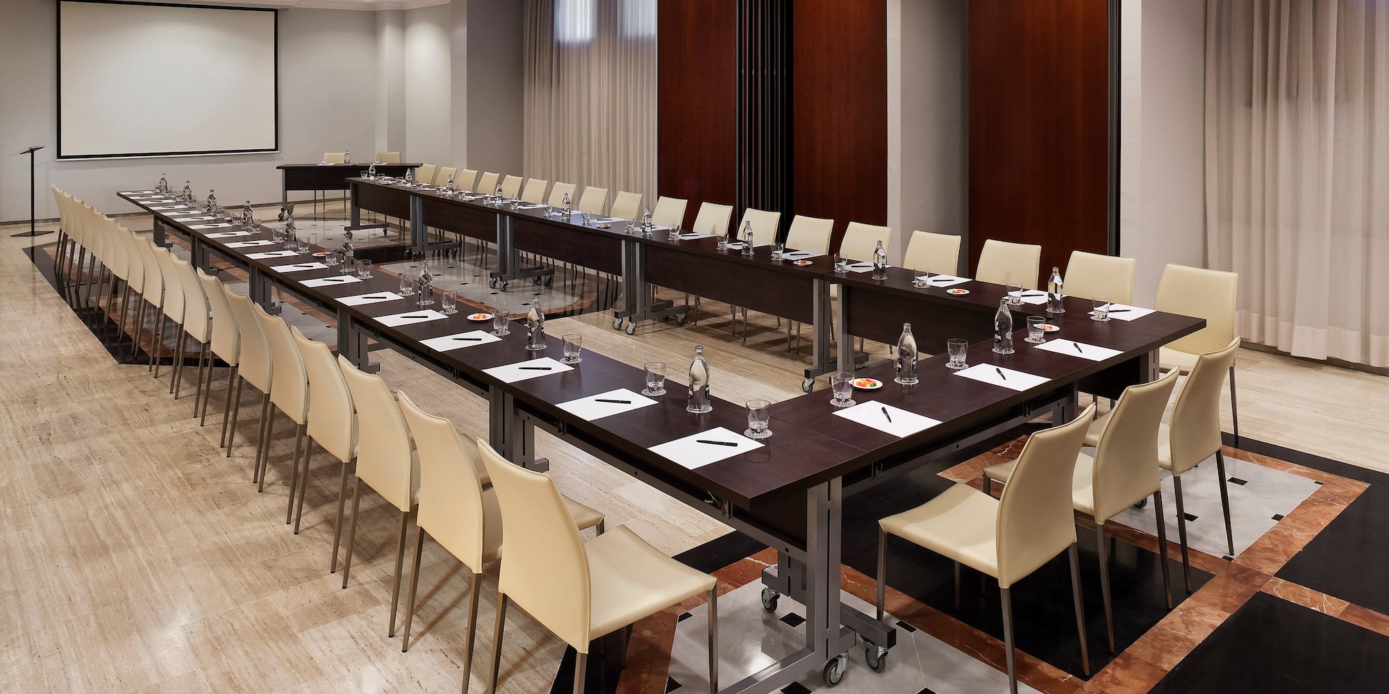 a room with long tables and chairs