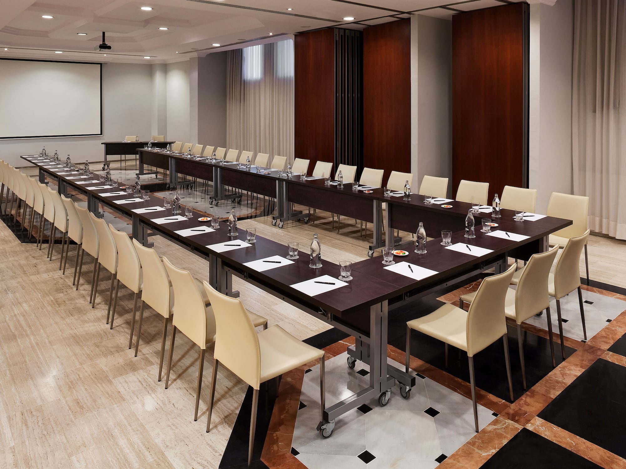 a room with long tables and chairs