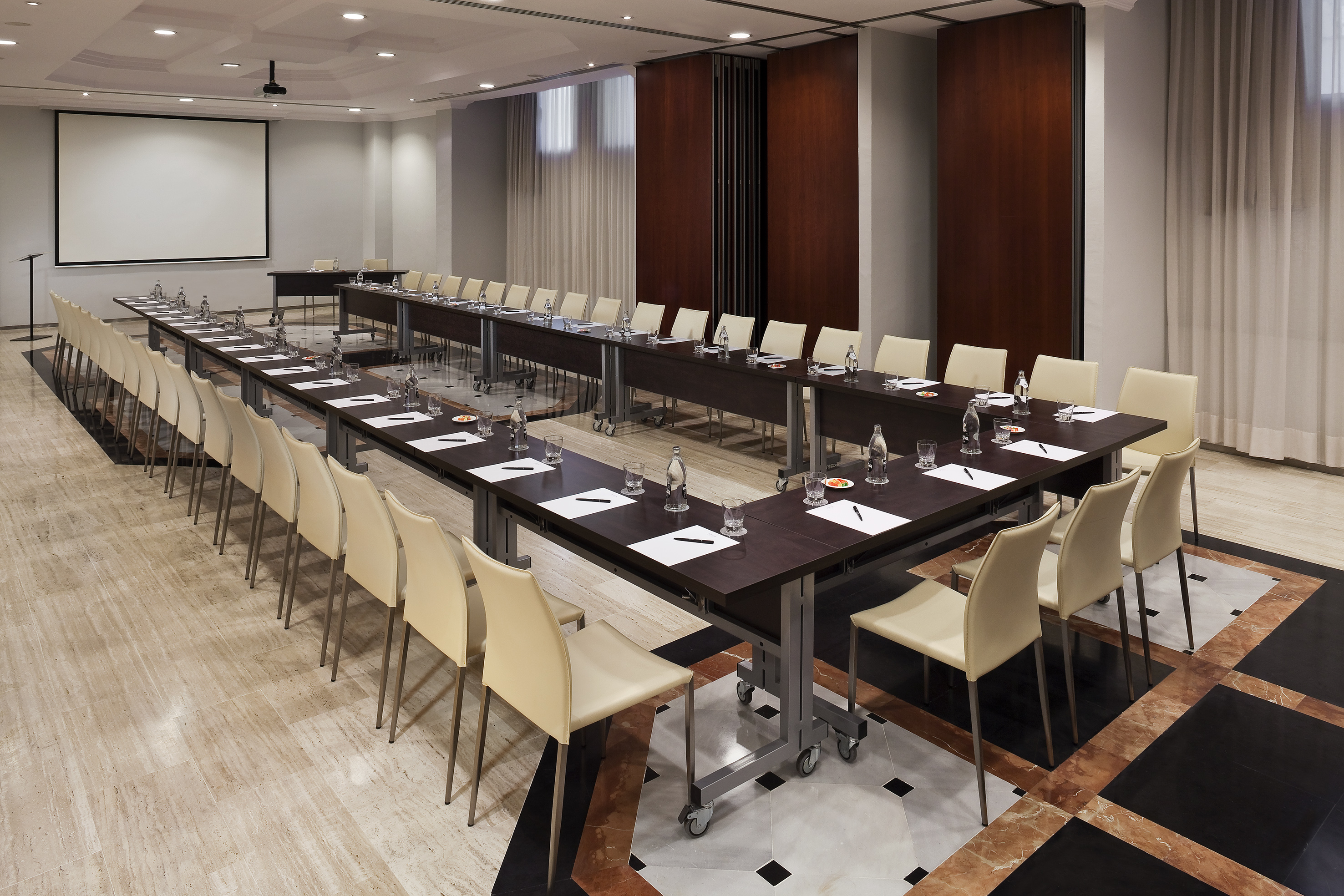a room with long tables and chairs
