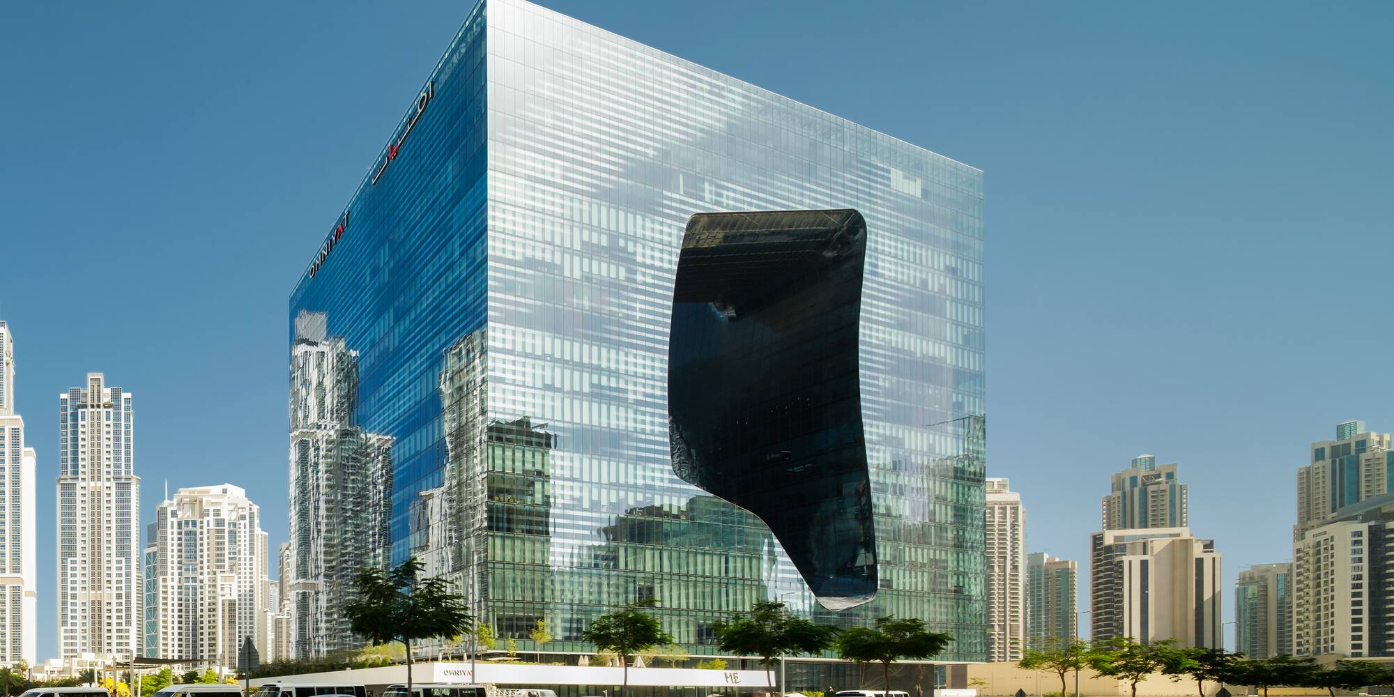 a large glass building with a large hole in the wall