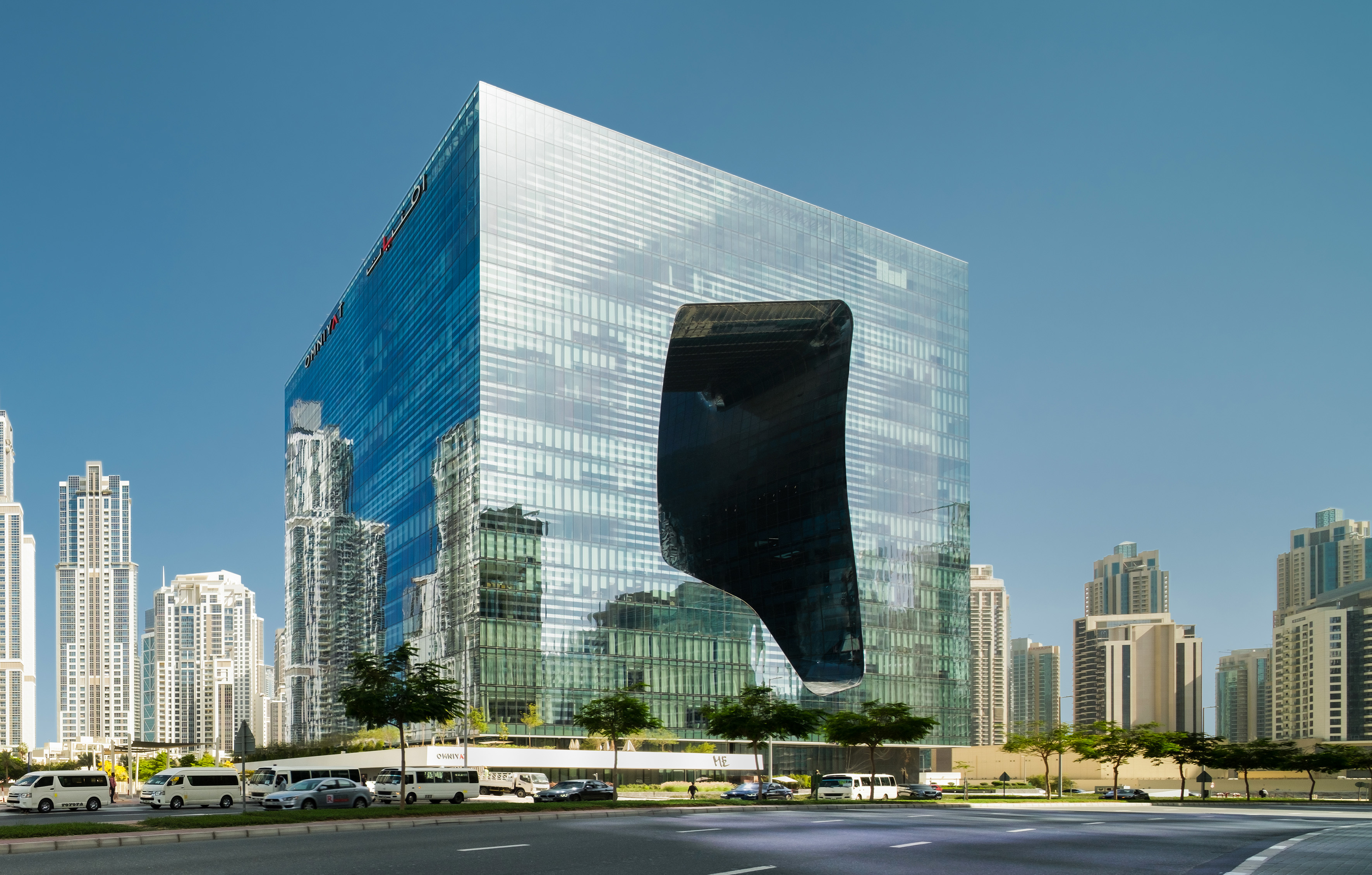 a large glass building with a large hole in the wall